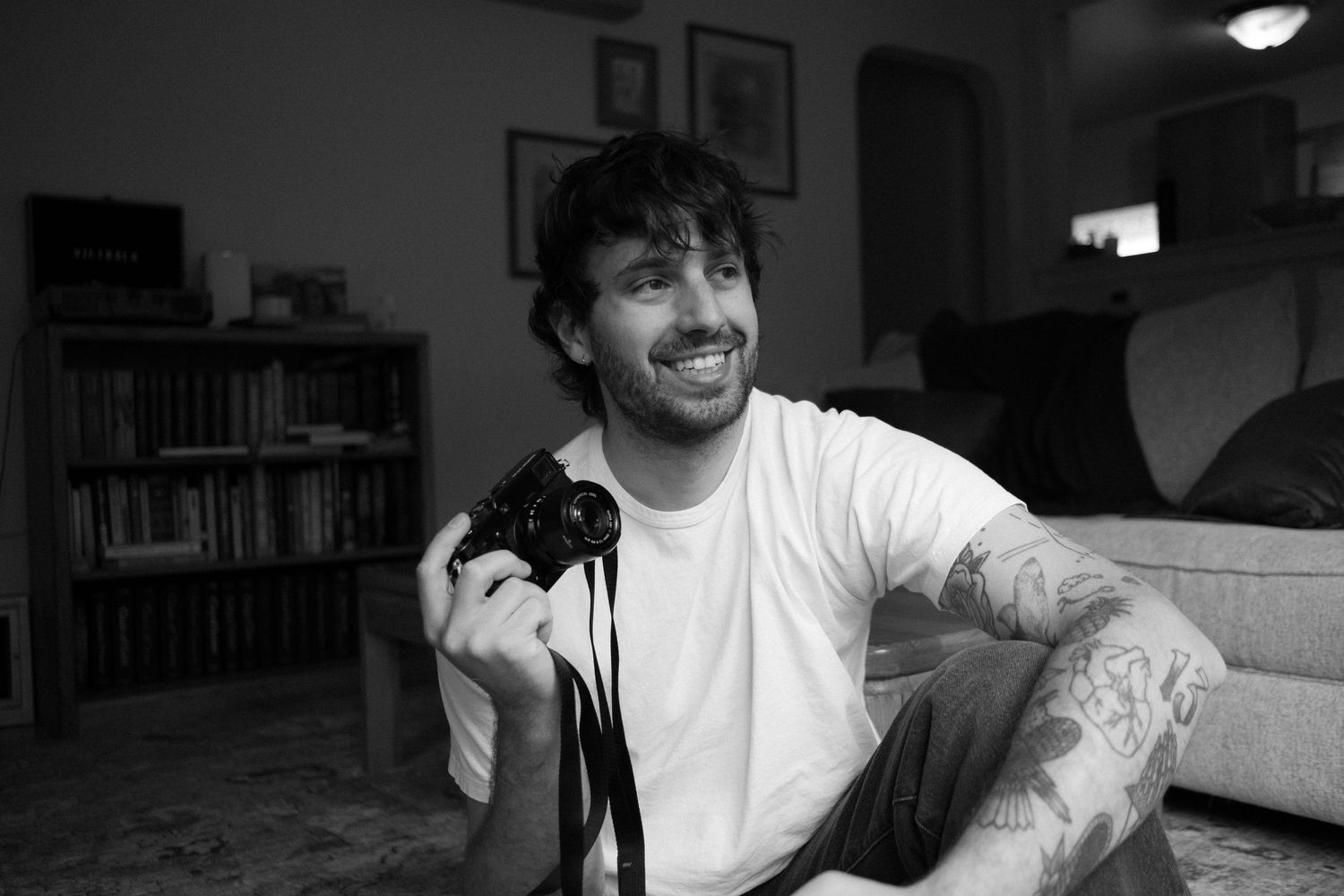 A joyful moment captured in black and white with someone holding a small black cat.