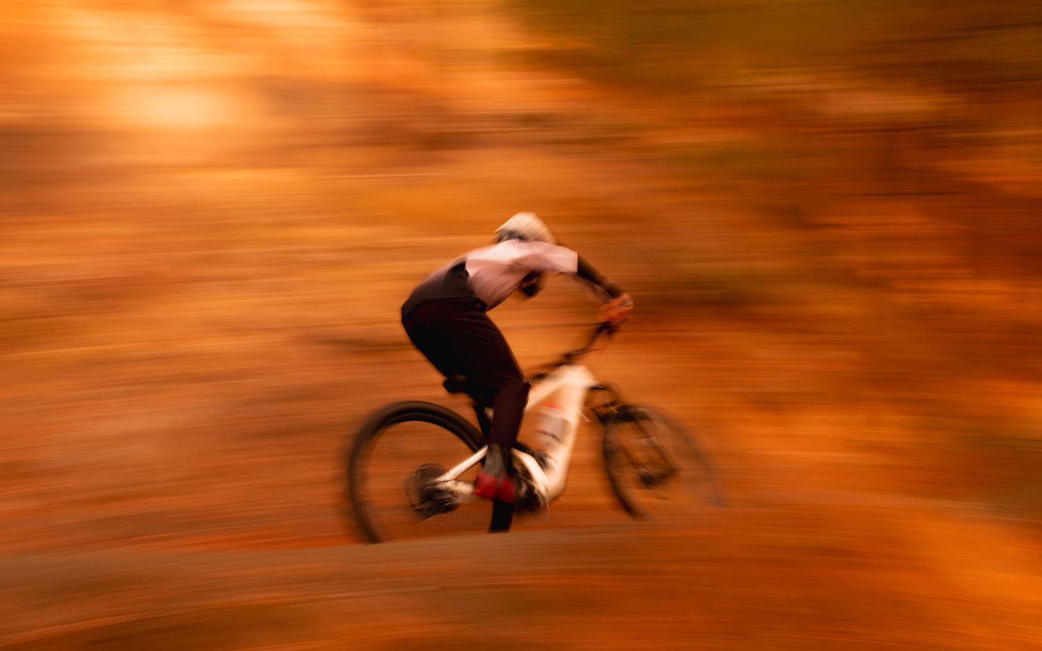 Abstract orange motion blur background with dynamic swirling patterns.