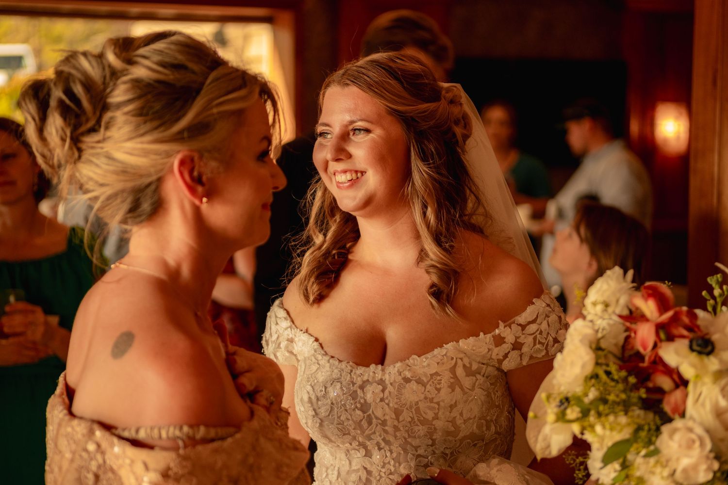 Reception celebration in warm, rustic venue with string lights overhead.