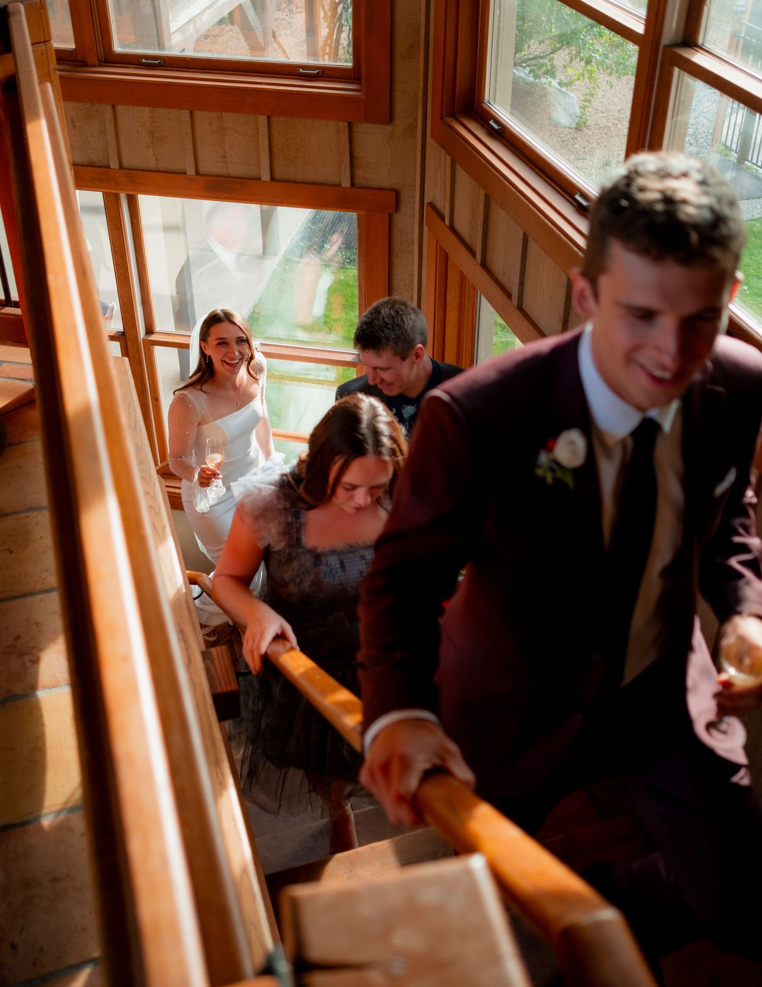 Wedding celebration candid moments in a sunlit wooden interior space.