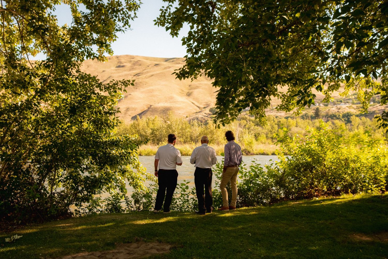 Small wedding gathering overlooking a scenic valley with rolling hills and trees.