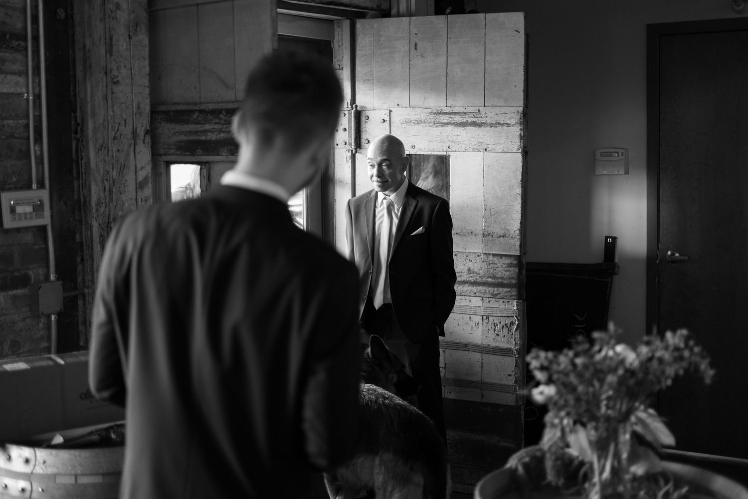 Moody black and white interior shots of a rustic venue.