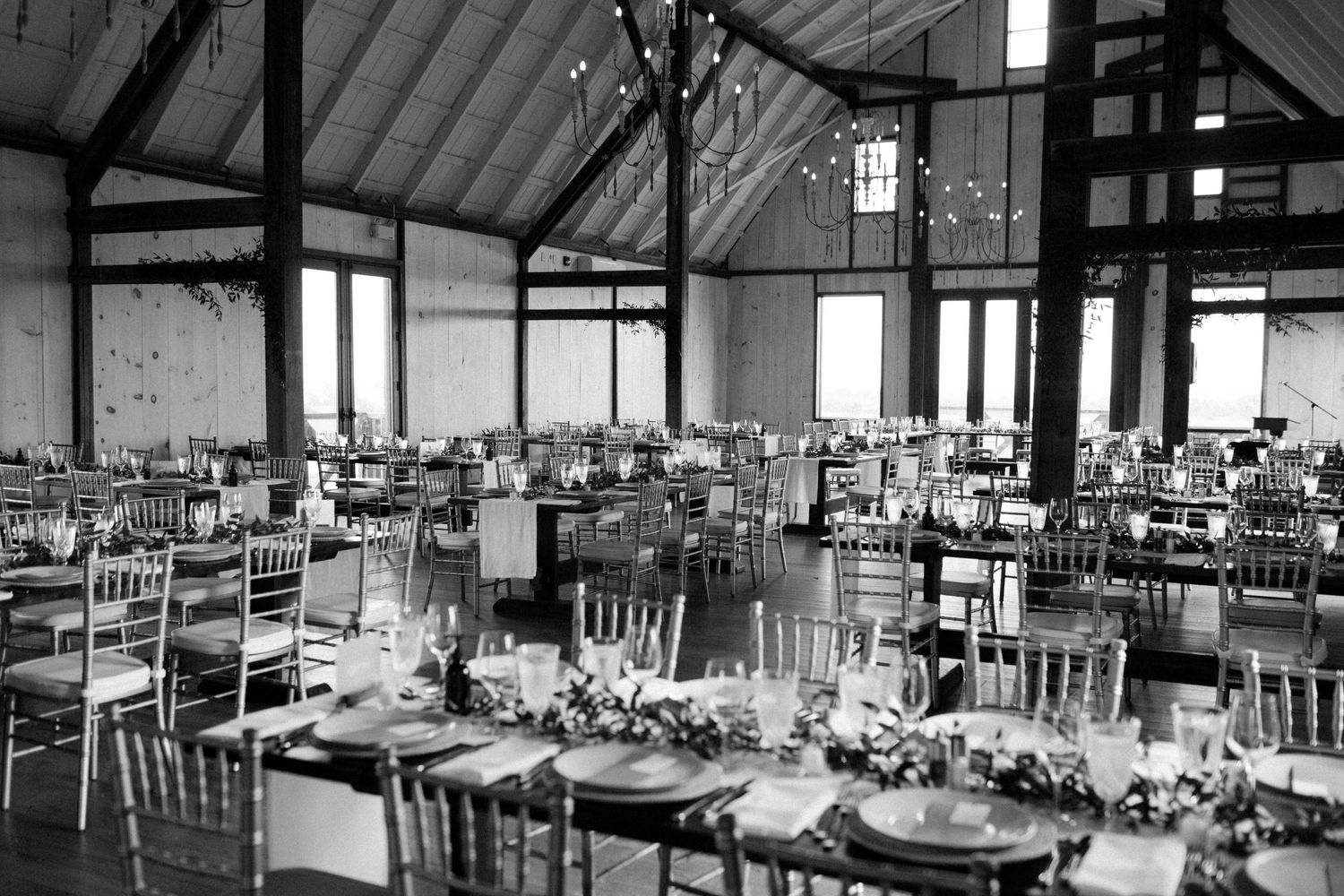 Elegant wedding reception venue with tables set for dining in black and white at Earth to Table Bread Bar