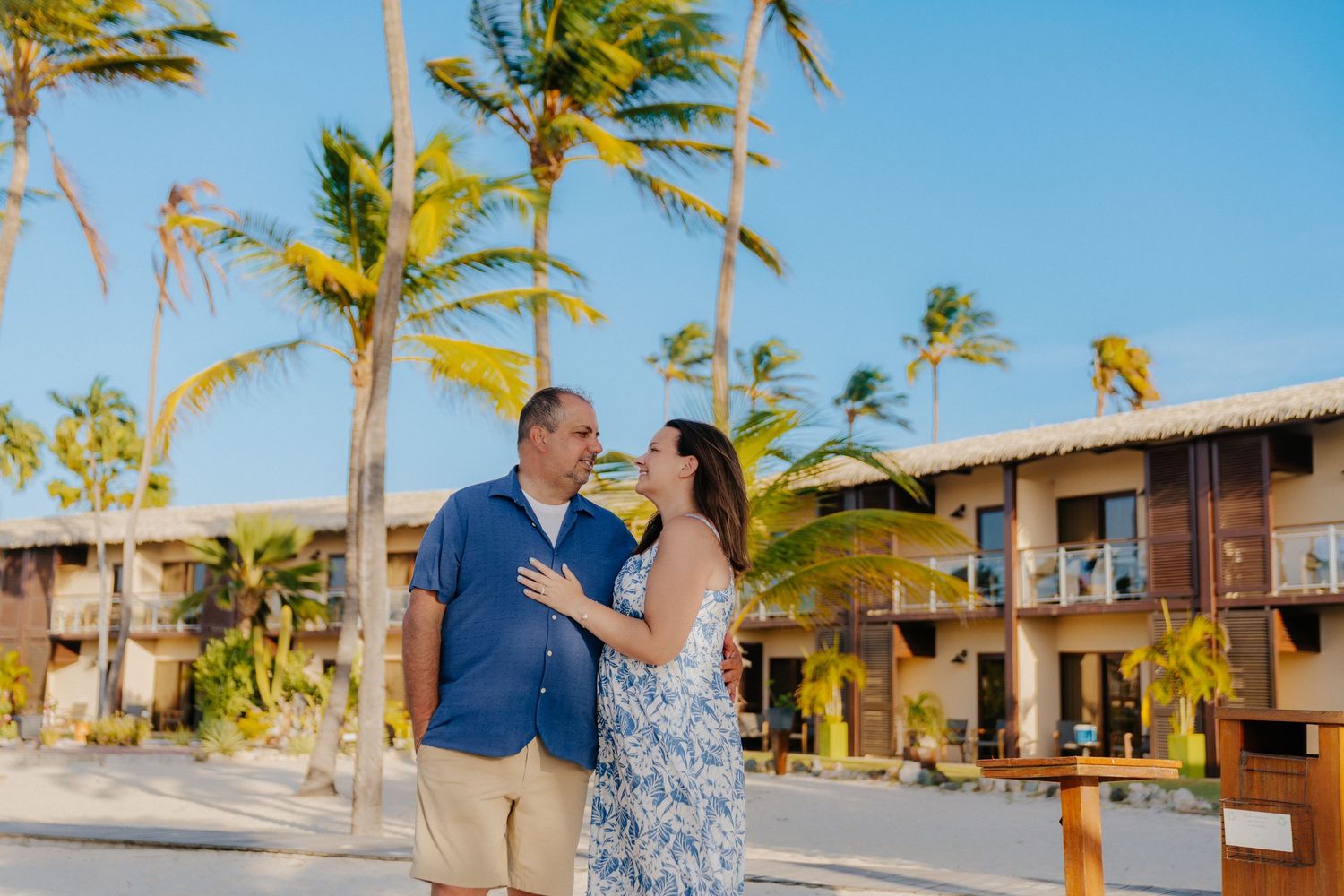 A beachfront resort property with palm trees swaying in the tropical breeze.