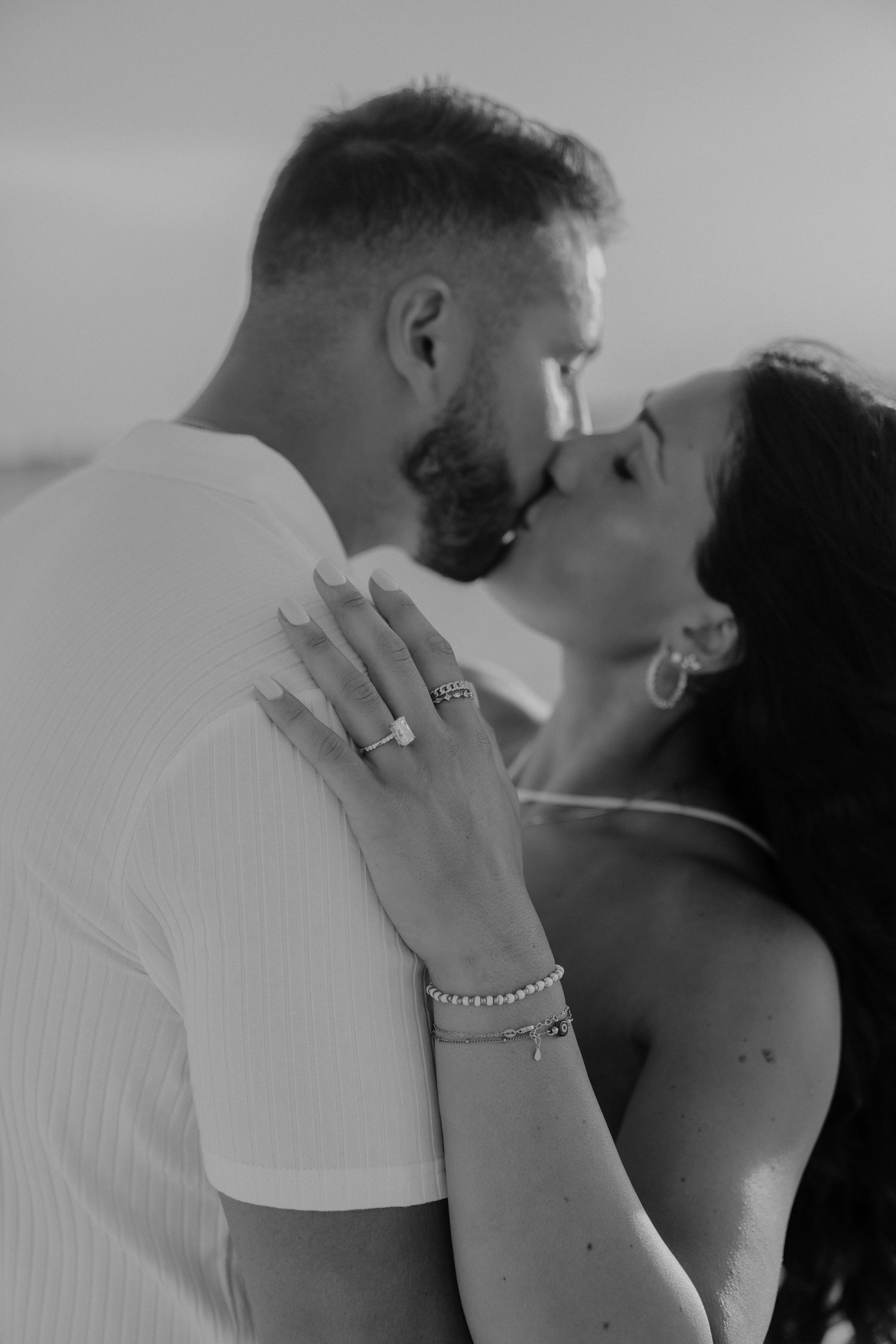 An intimate black and white portrait series capturing tender moments between a couple.