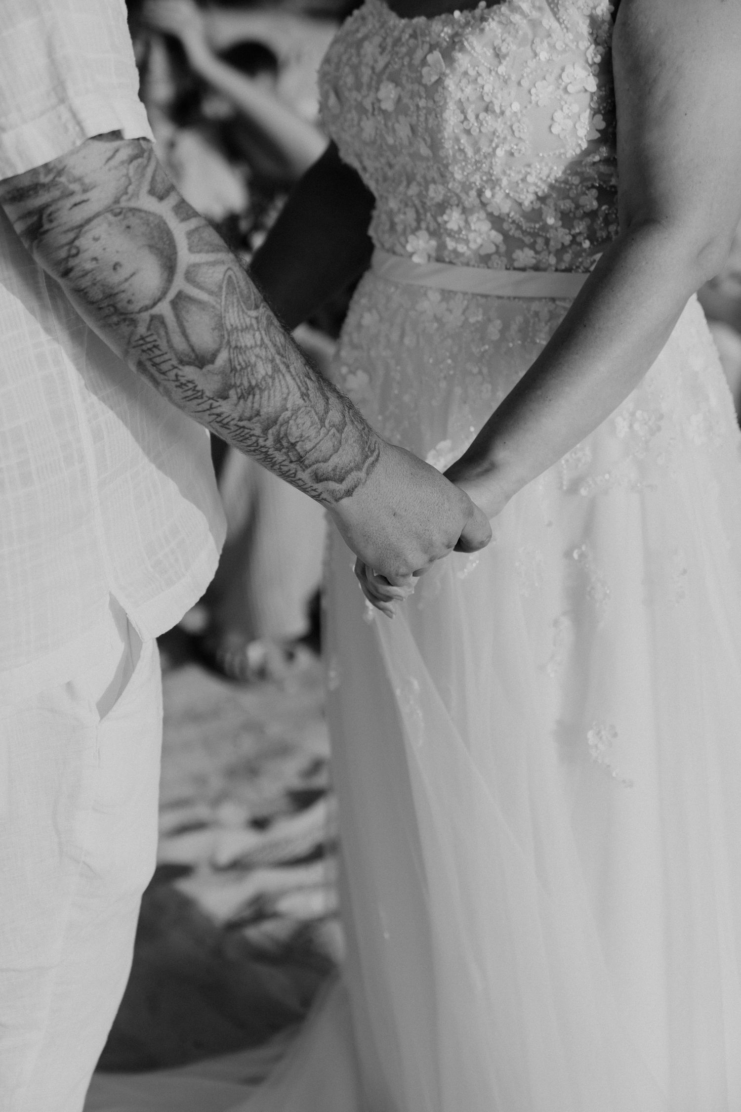 Close-up details of elegant white wedding attire.