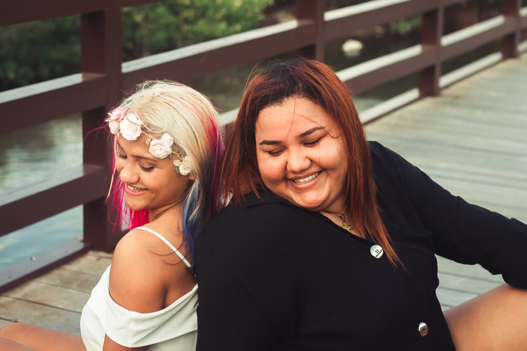 Laughing couple sharing a romantic moment together on a wooden deck.