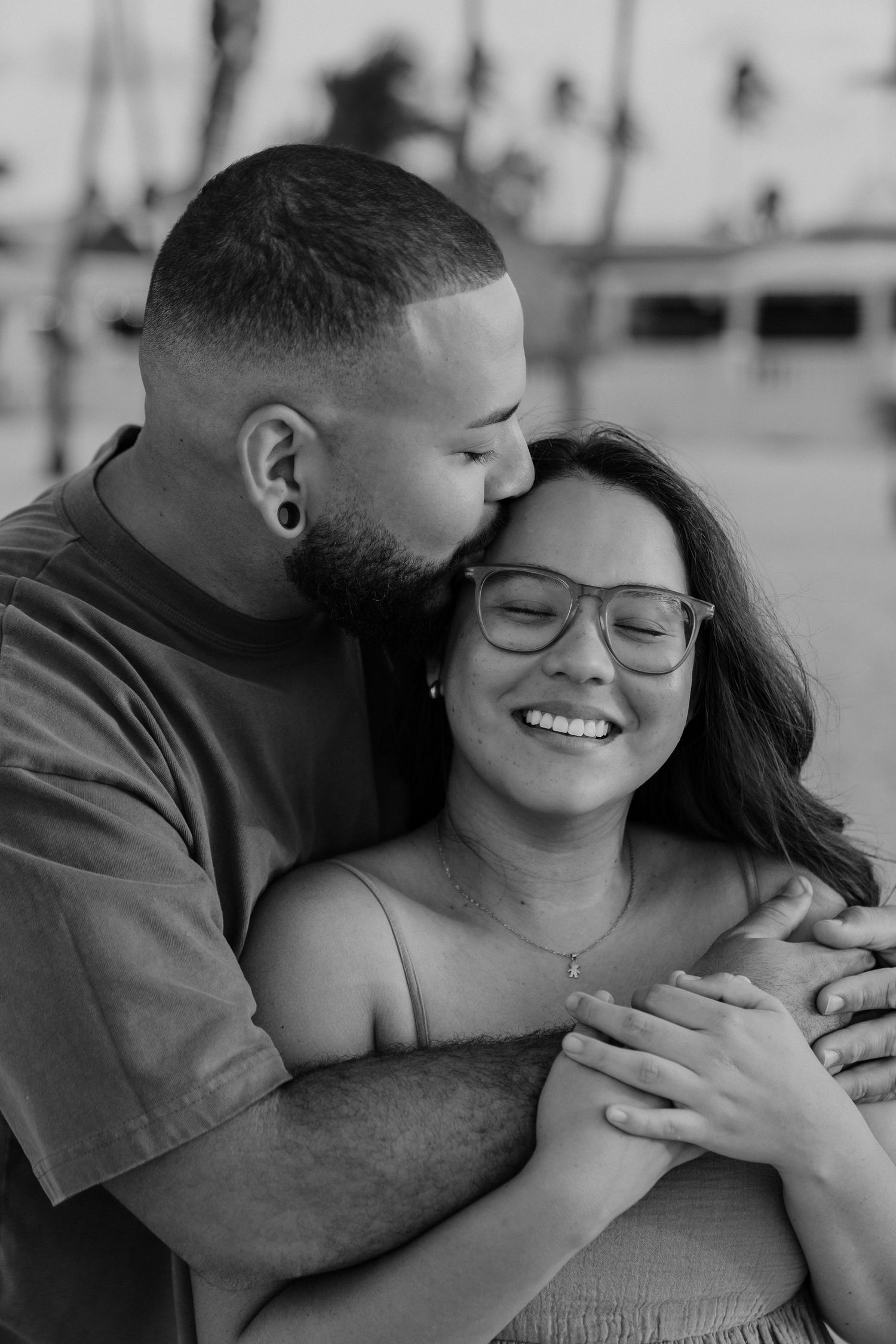 A romantic black and white photo sequence showing a couple embracing and sharing tender moments together.