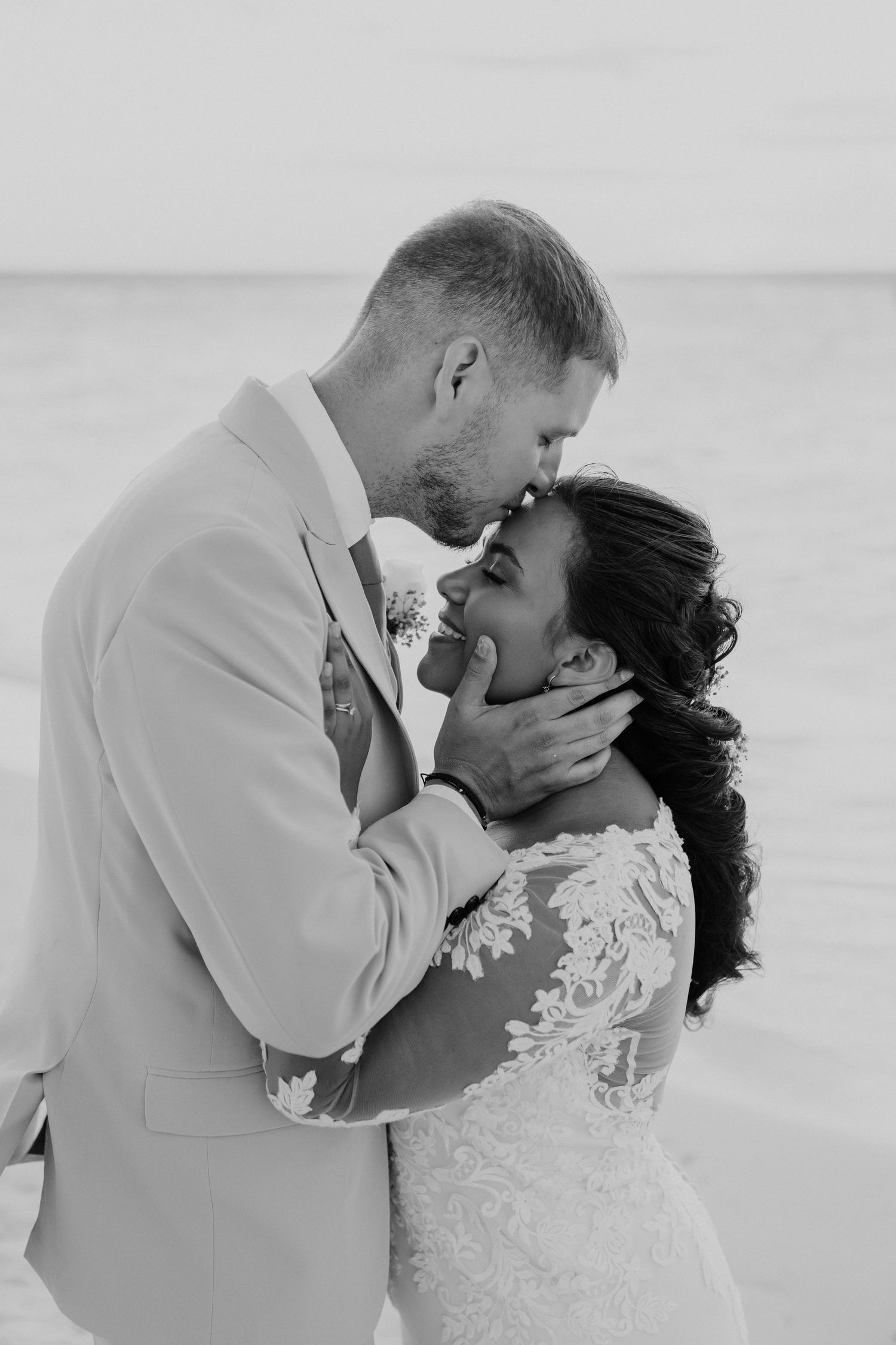 Black and white wedding photos showing tender moments between a couple.