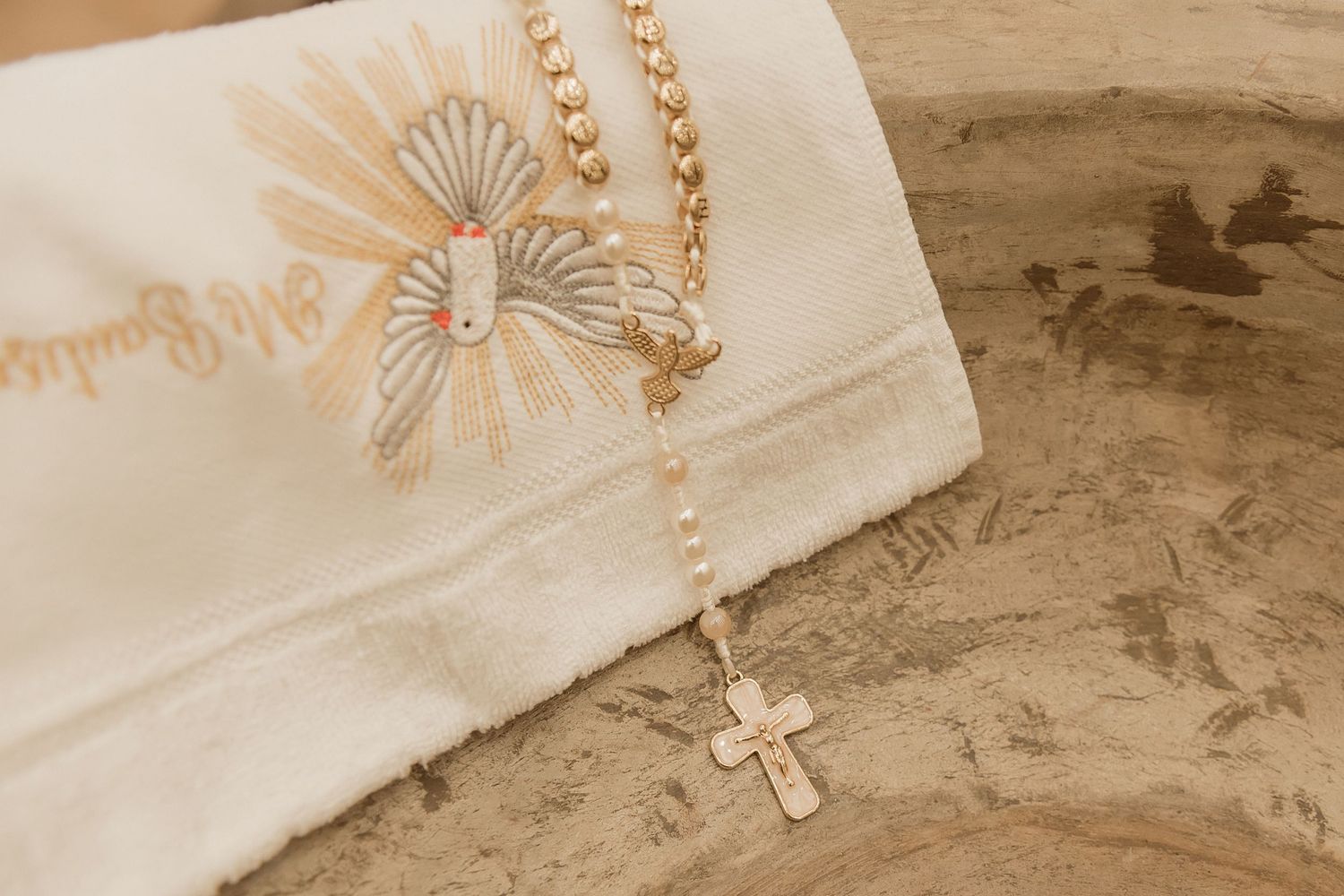 Delicate pearl necklace arranged in a spiral pattern on vintage paper with decorative floral designs.