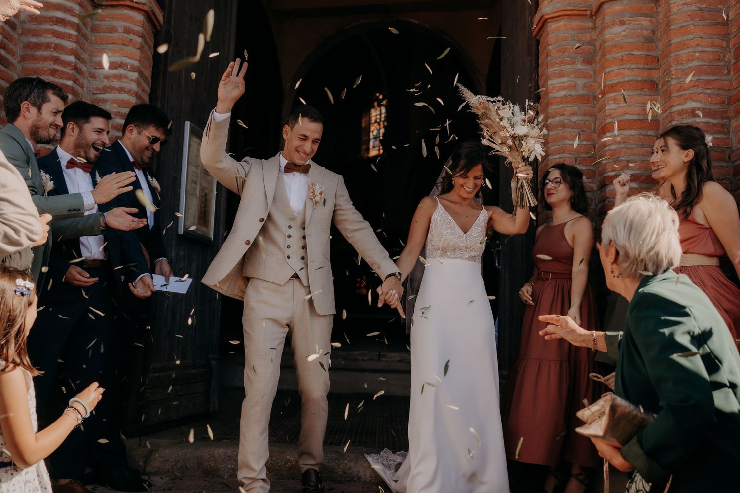 Wedding celebration with guests dancing and enjoying festivities in a rustic venue.
