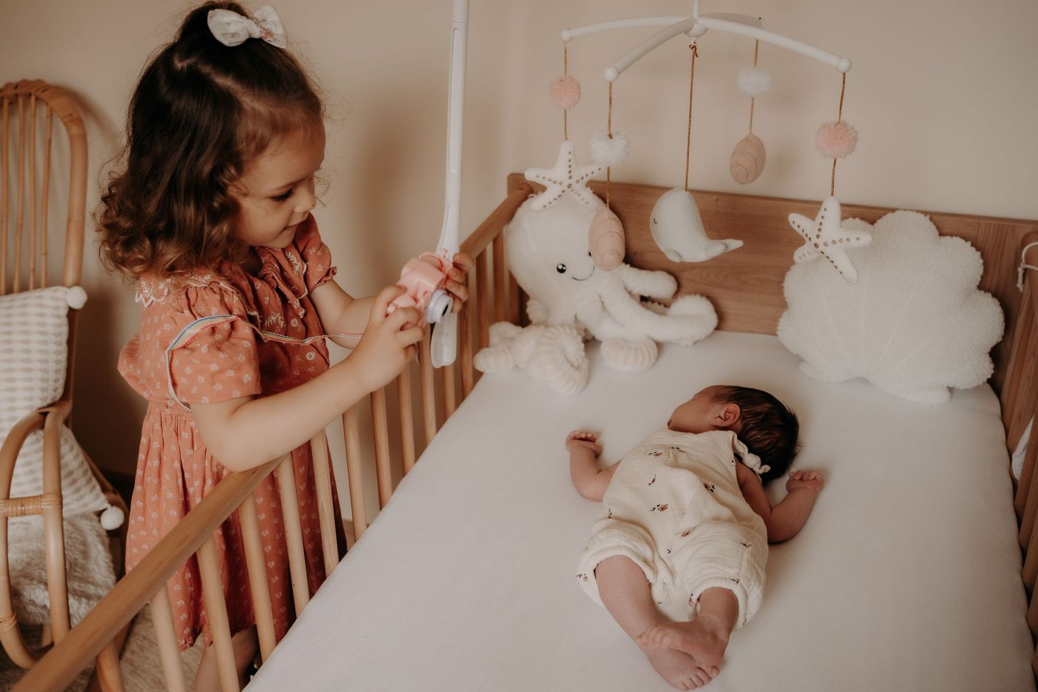 Nursery scene with crib and mobile showing tender family moments.