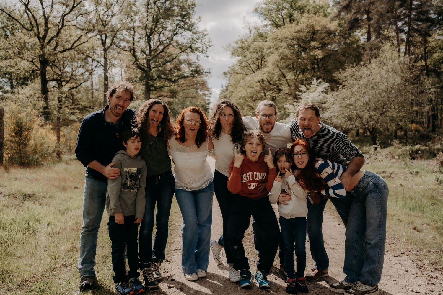 Casual family group photo taken outdoors in natural setting.