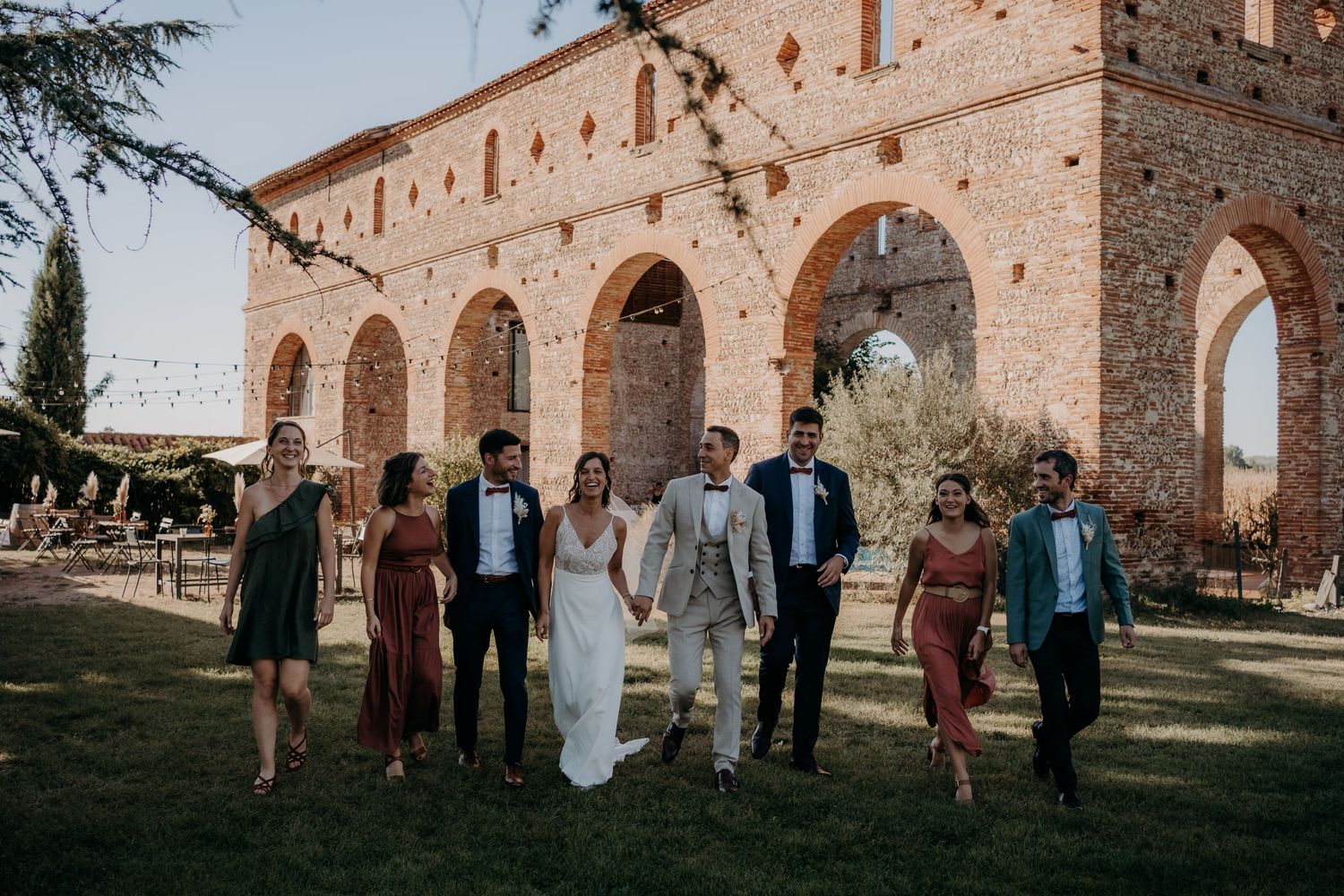 Wedding group portrait with bridal party lined up at historic venue.