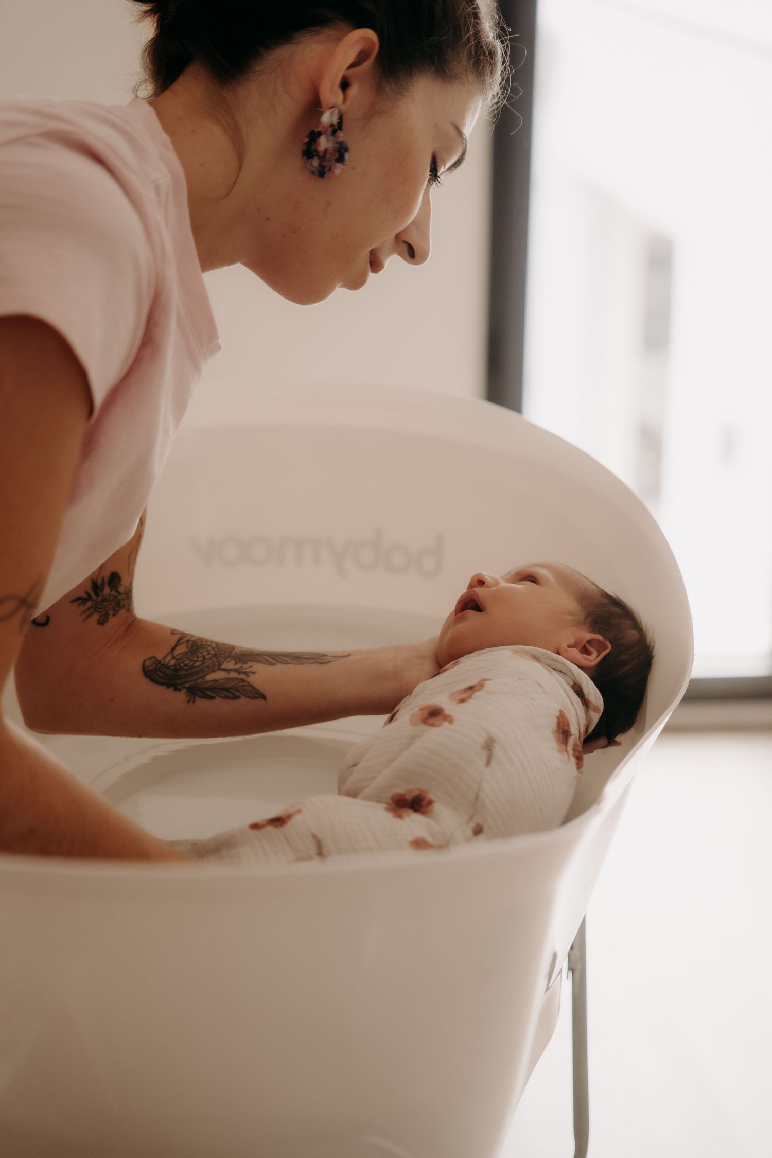 Gentle bathing scene captured in soft natural light through window.
