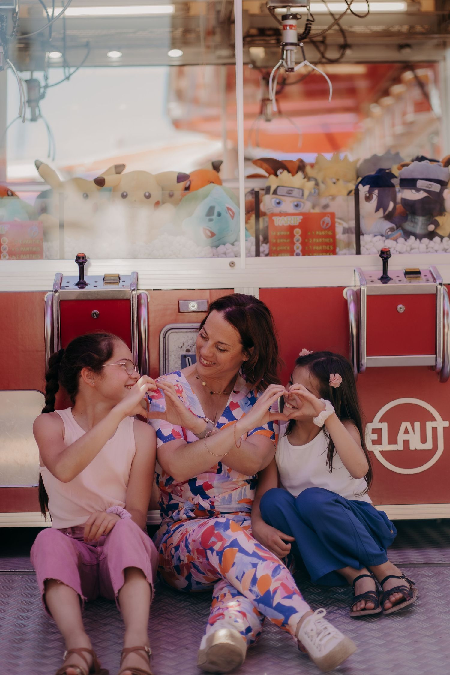 Family enjoying playful moments at an arcade with colorful gaming machines.