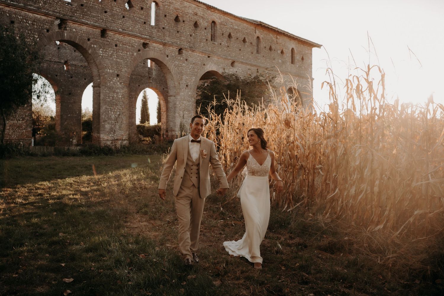 Dreamy wedding photos captured against ancient stone walls at golden hour.