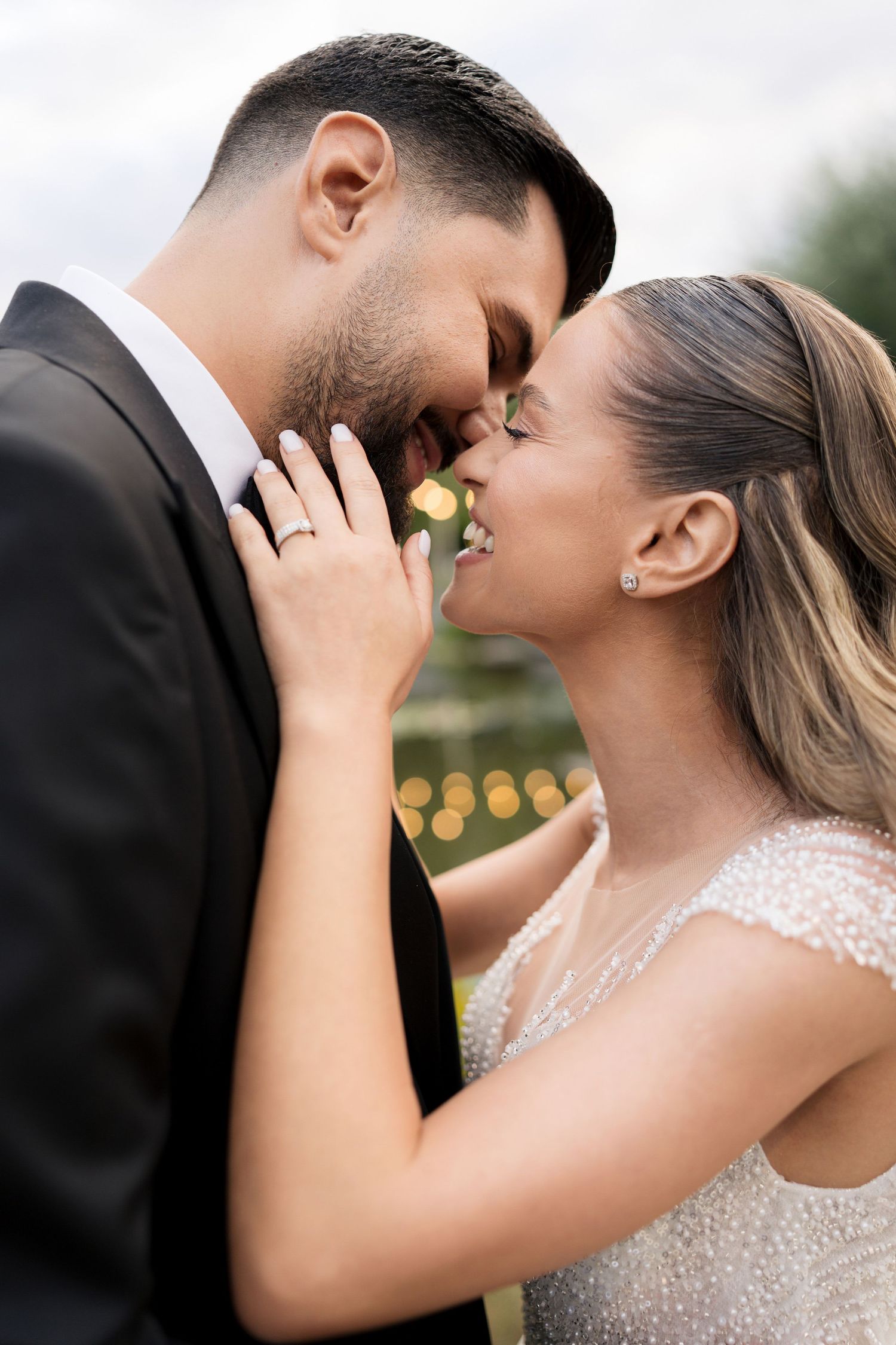 Romantic wedding portrait of couple sharing an intimate moment outdoors.