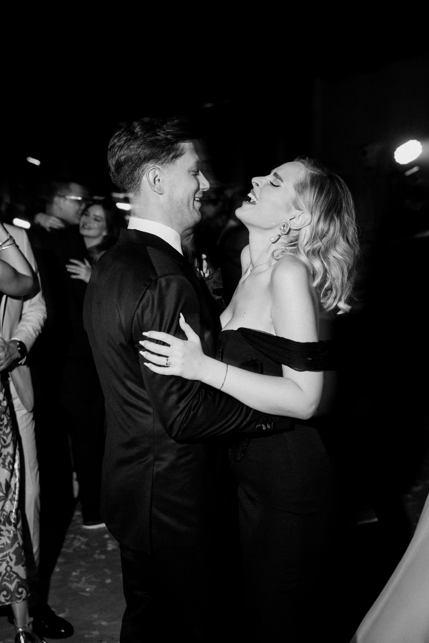 Intimate black and white dance floor moments at an evening wedding reception.