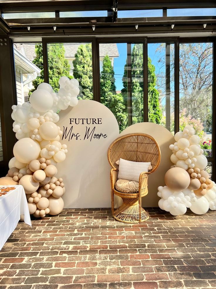 Bridal shower details including backdrop, balloons, and celebration decor.