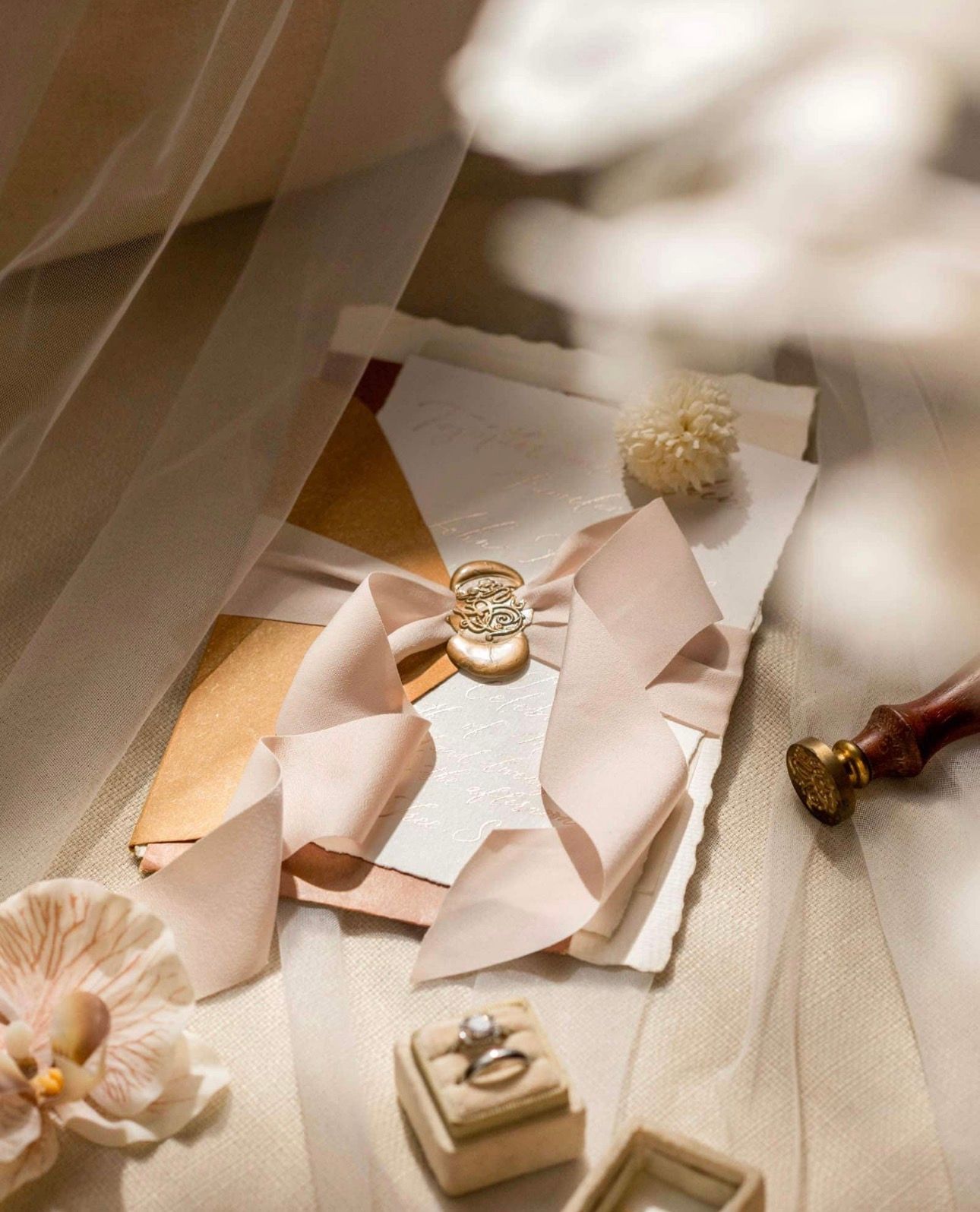 Wedding stationery details including invitations and rings styled for a romantic wedding aesthetic.