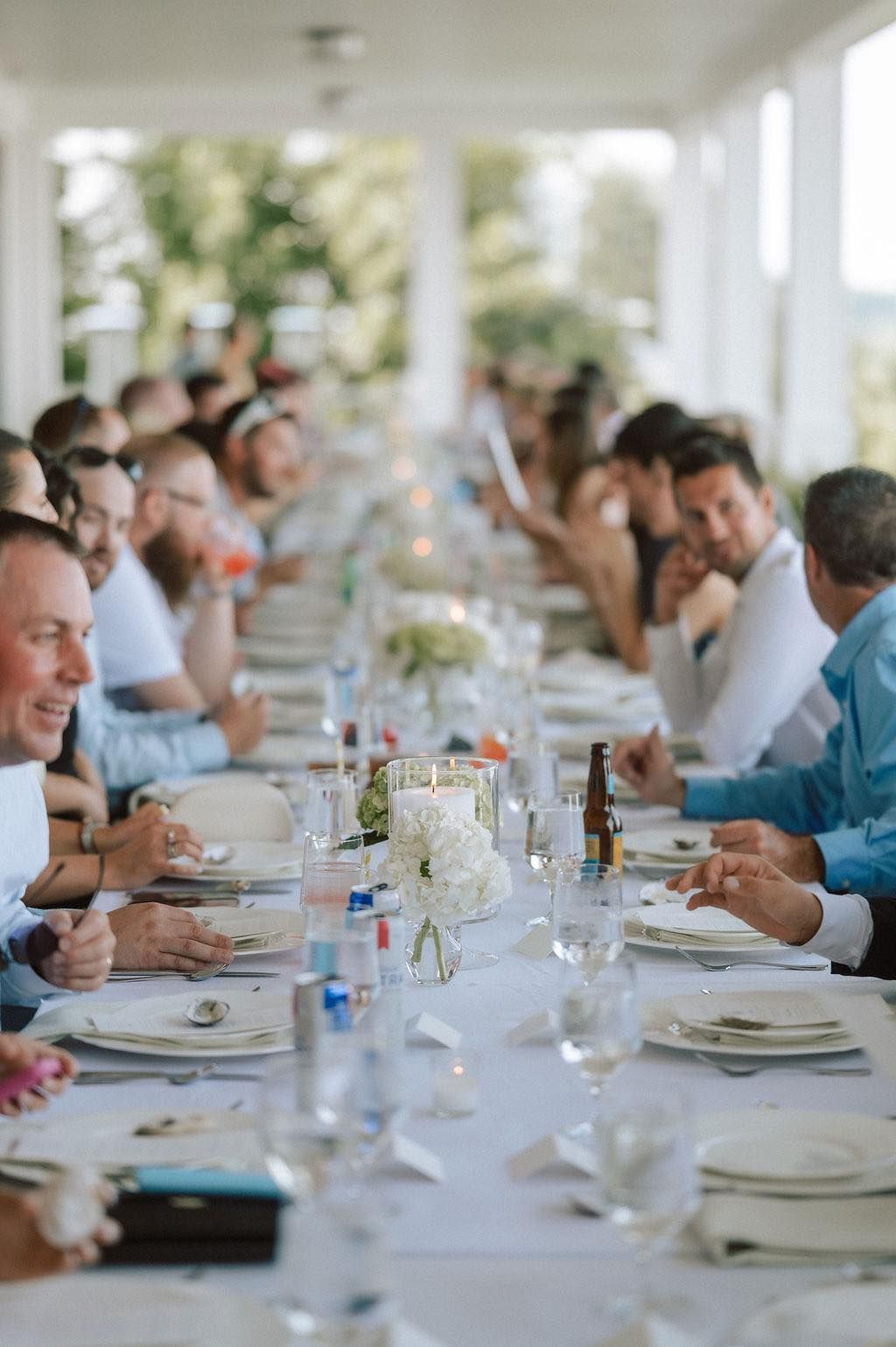legant wedding tablescape featuring candlelight and neutral-toned floral centerpieces.