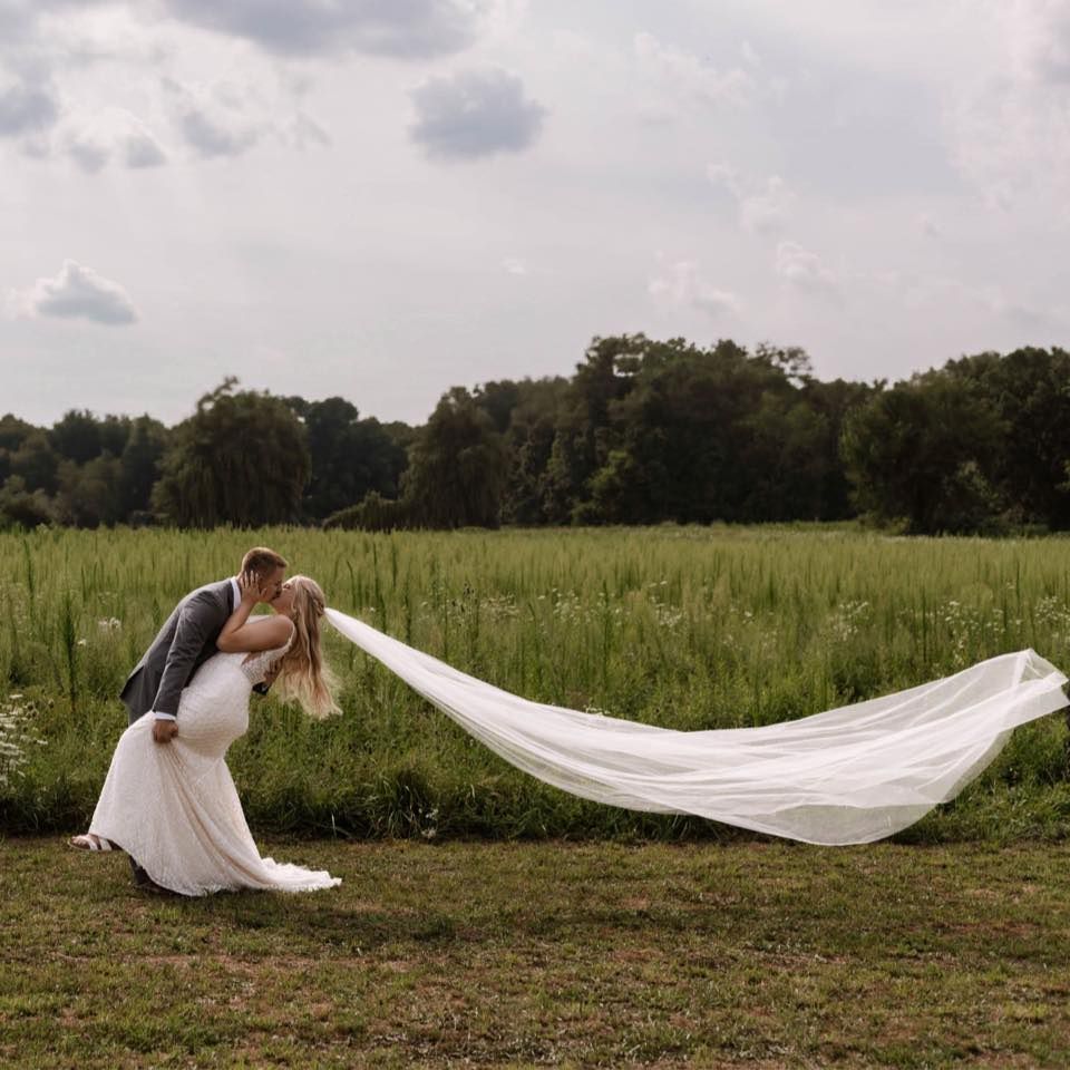 Bride and groom sharing an intimate kiss during their wedding day portraits.