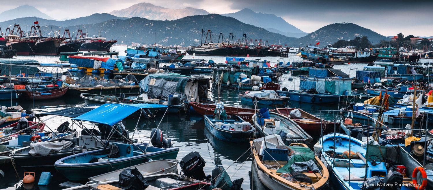 Crowded fishing harbor with colorful boats moored at Cheung Chau Hong Kong.