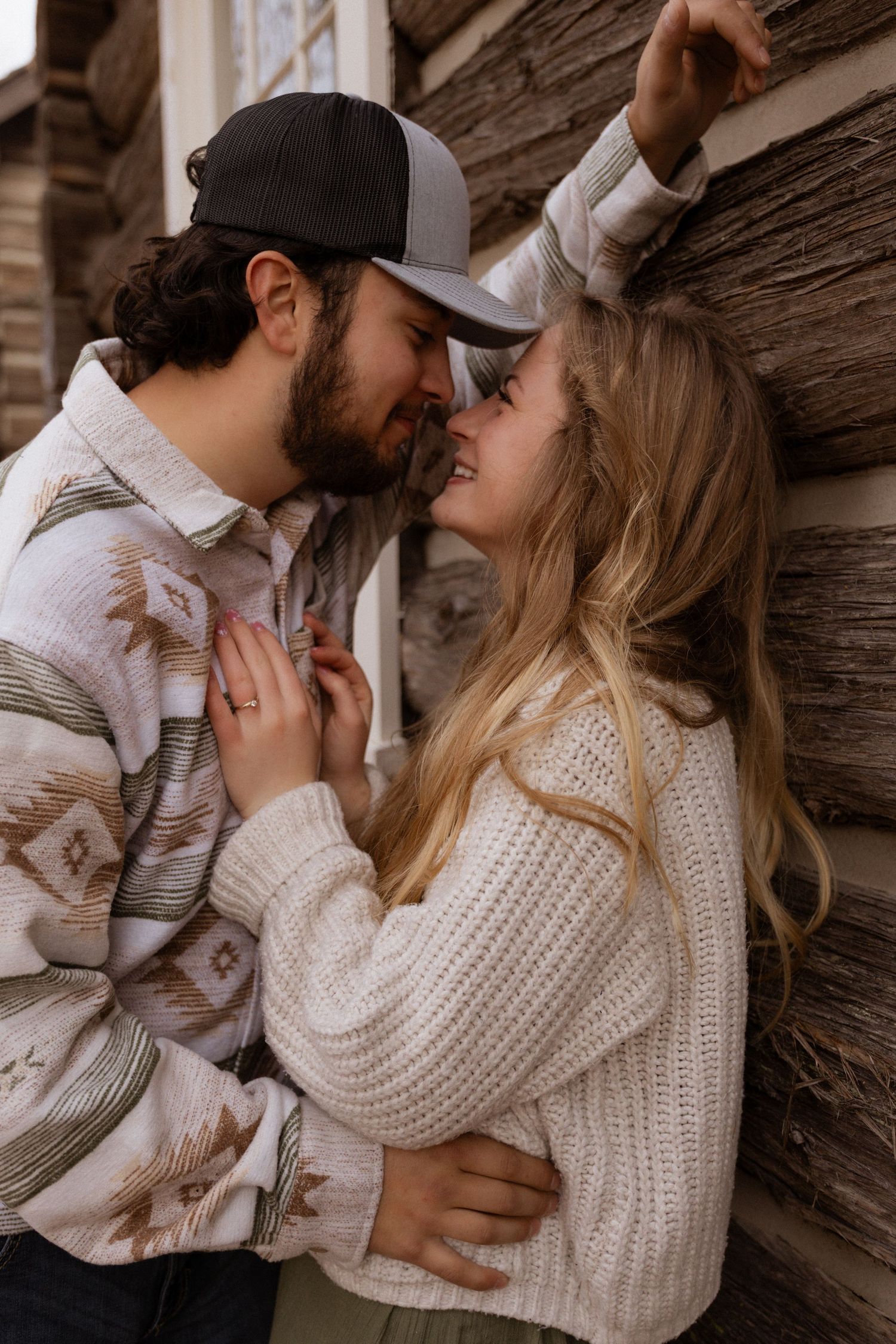 An engaged couple snugging in close during a couples session in West Glacier Montana