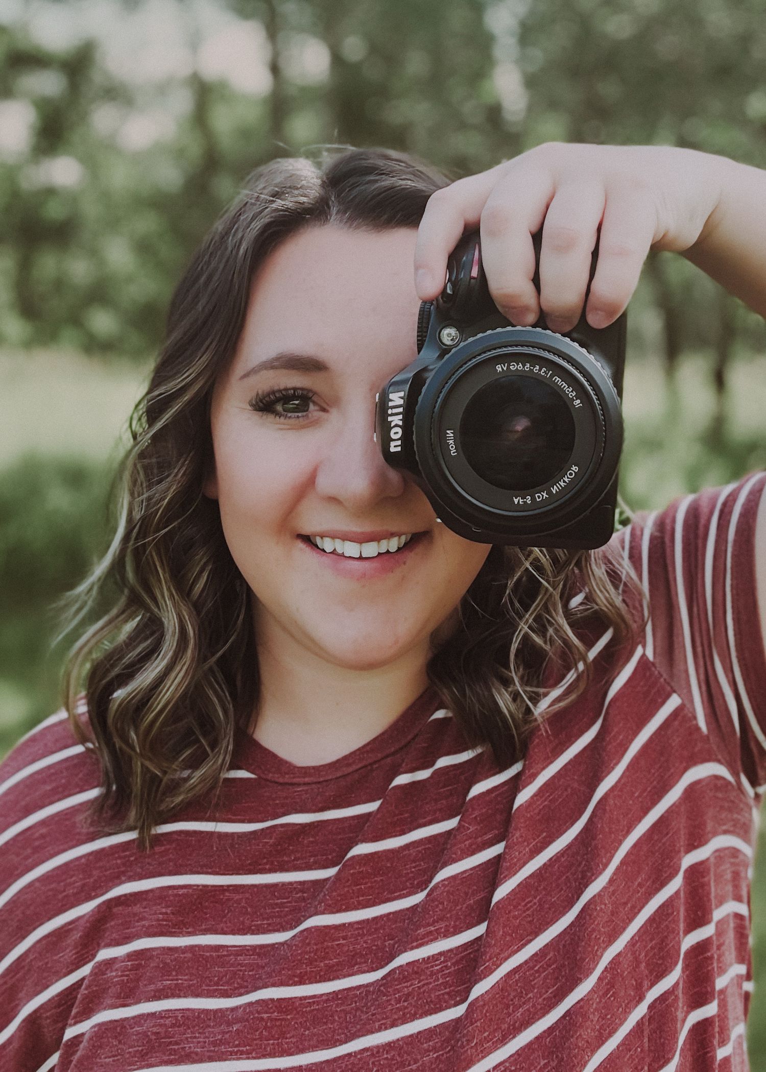 Jessica Lentz Photography posing with her camera for a headshot for her business in Havre Montana