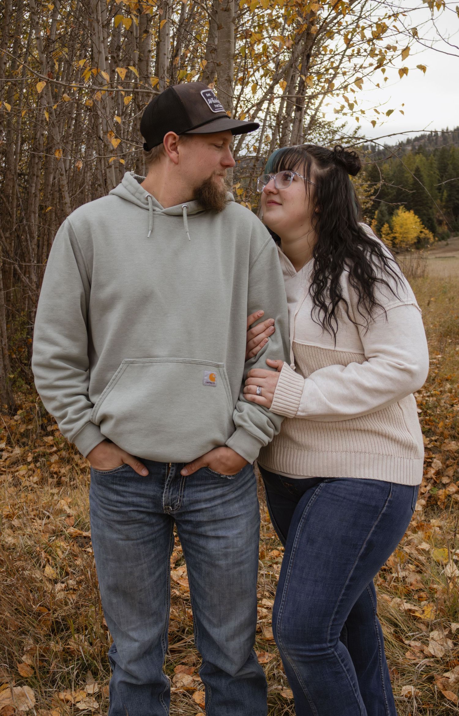 A couple embracing looking at each other during a family fall session in Kalispell Montana