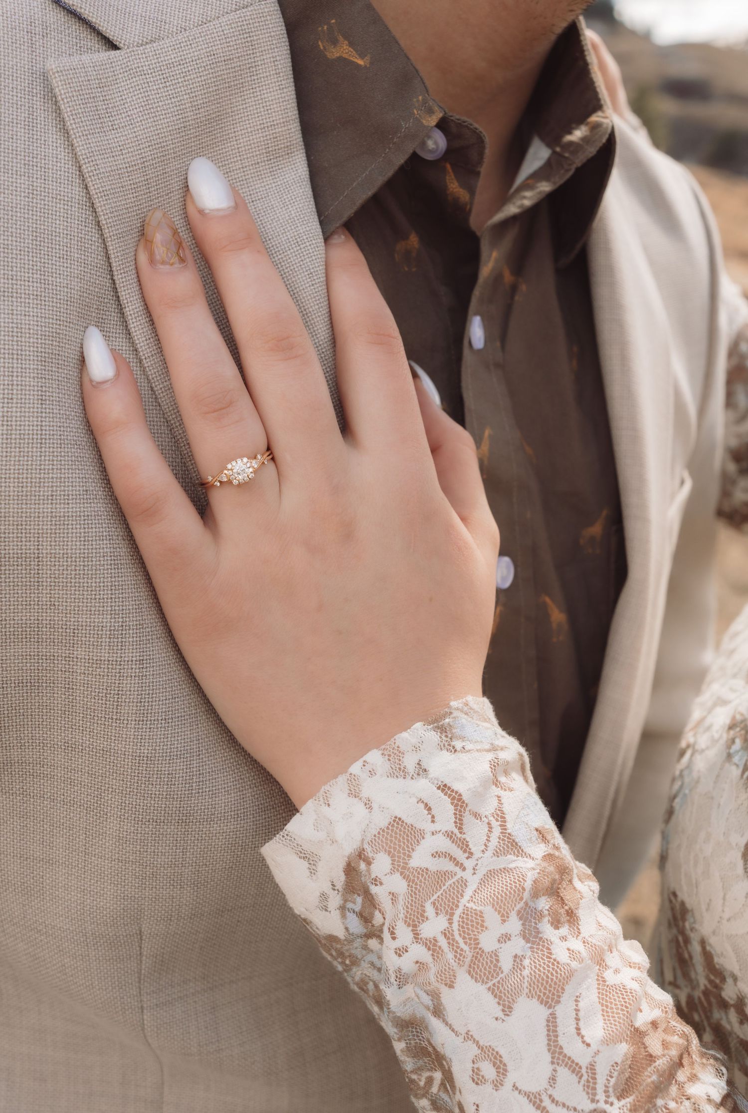 A woman's hand laying on her fiancés chest during an engagement session in Havre, Mt