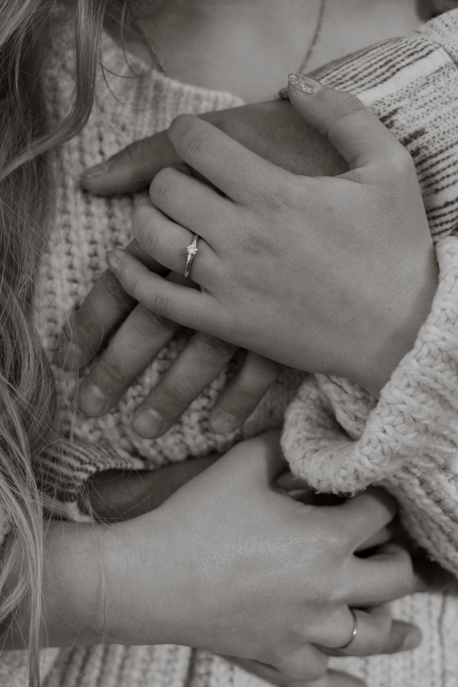 A close up of an engaged couples hands in West Glacier Montana