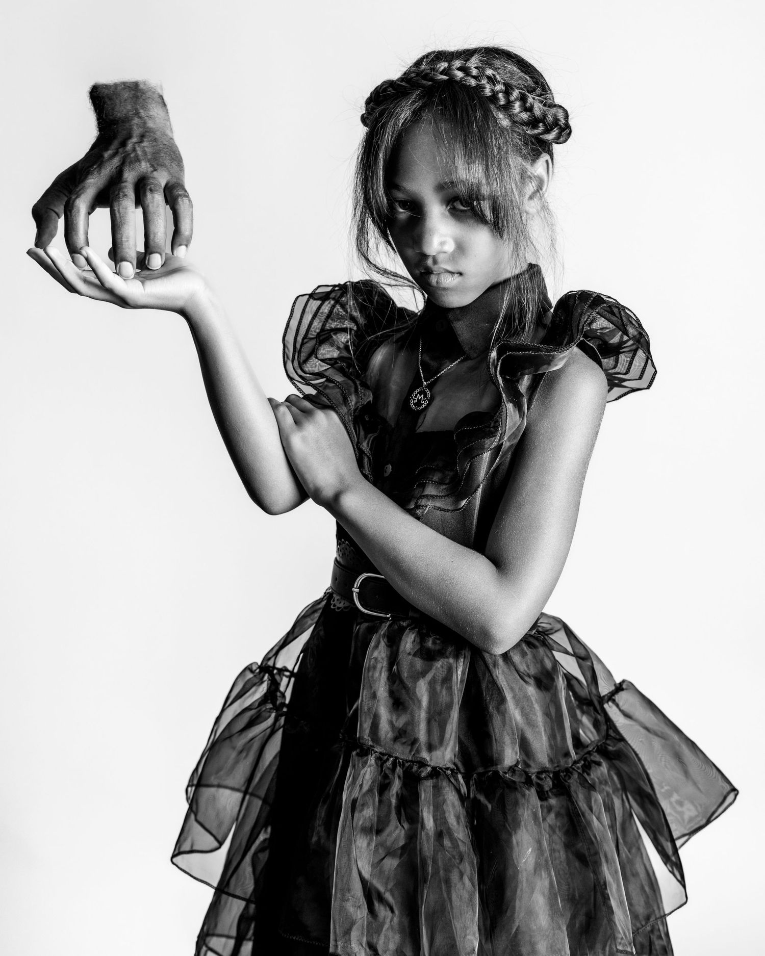 A series of black and white artistic portraits showing a figure in a dark dress against a light background.
