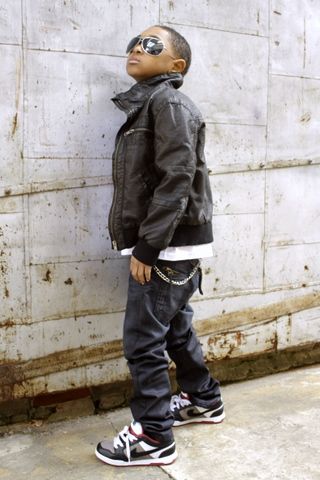 Five sequential photos showing a child in dark clothing and sneakers posing against a concrete wall.