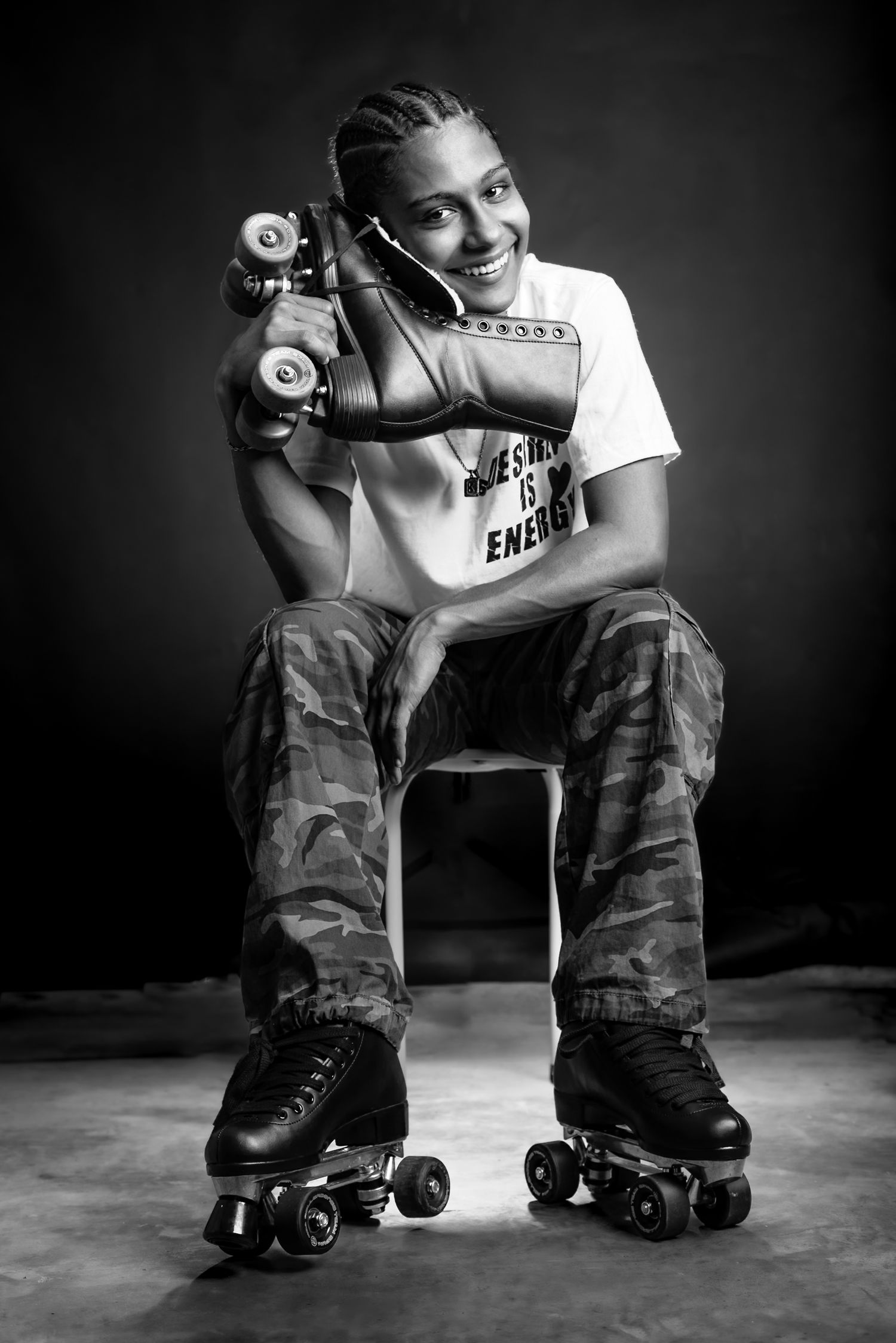 A series of black and white photos showing someone in casual wear and camo pants posing with roller skates.