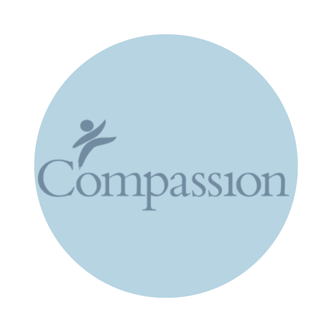 Compassion International logo in gray on a soft blue circular background.