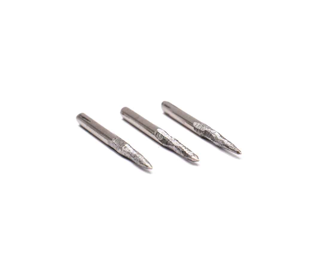 Three silver metal screwdriver bits with pointed tips on a white background.