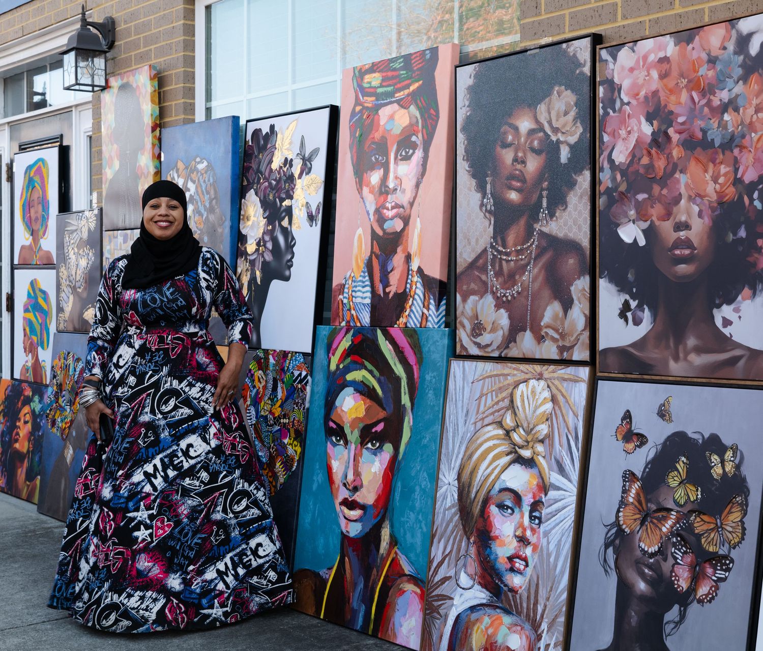 Colorful urban street art murals featuring portrait paintings on brick walls in an outdoor gallery setting.
