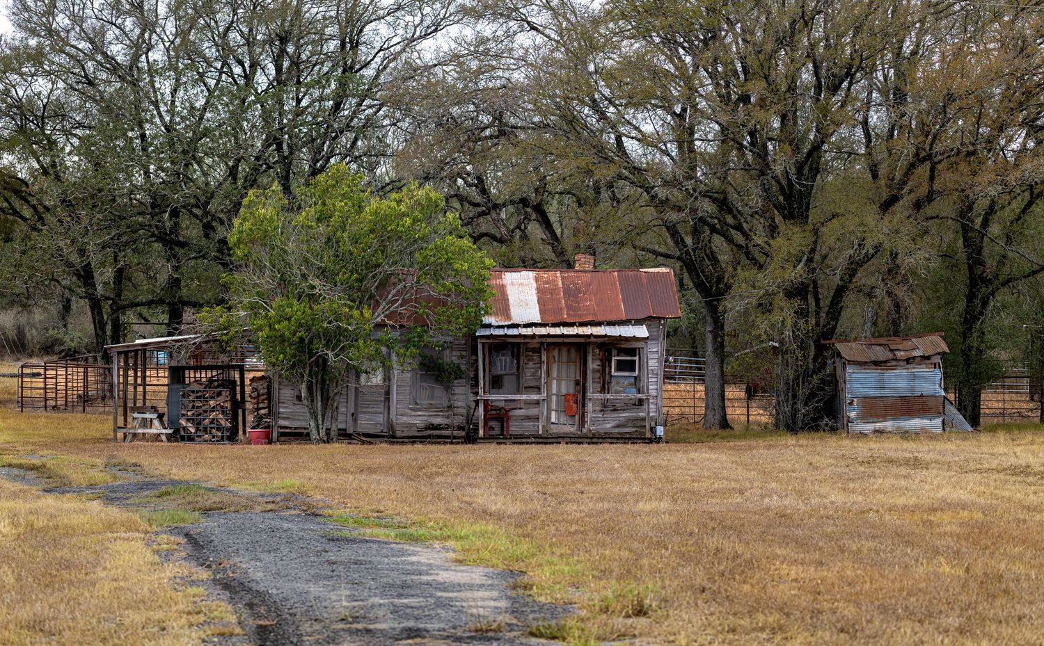 A man inside a work car carrying tools and belongings, capturing a moment of daily life and survival in a small Texas town.
