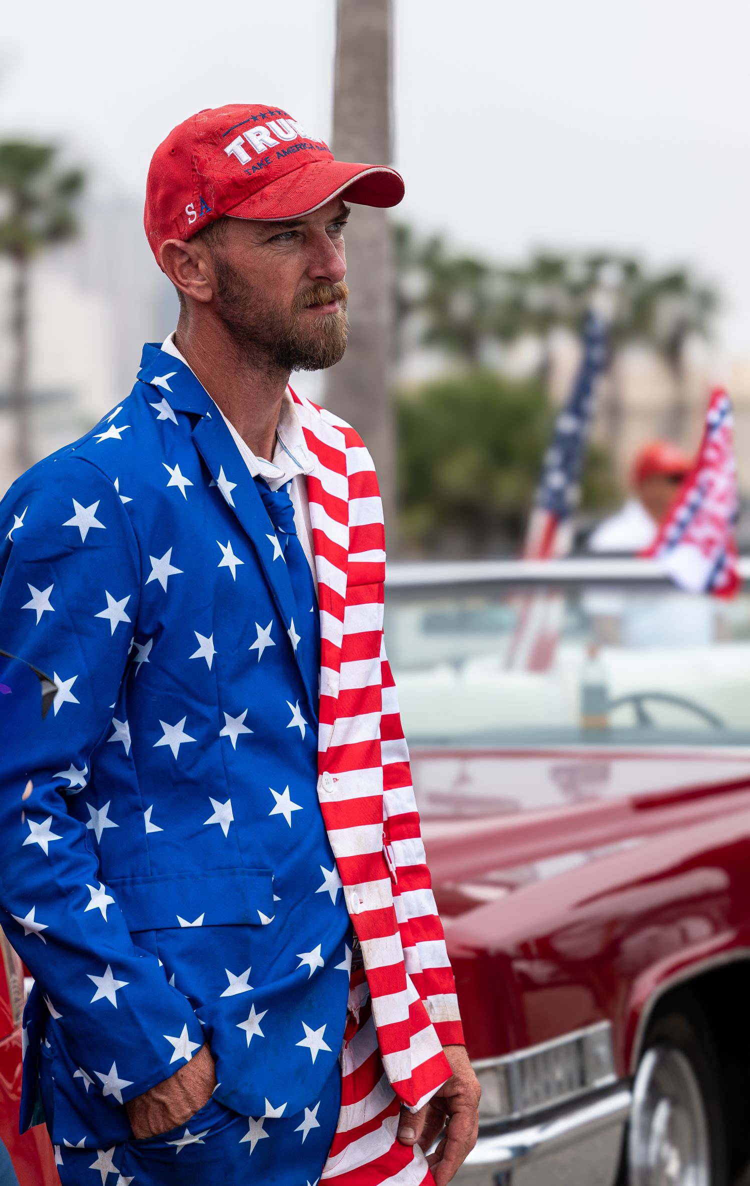 Man dressed in American flag-themed clothing at a public event, reflecting personal expression and community identity.