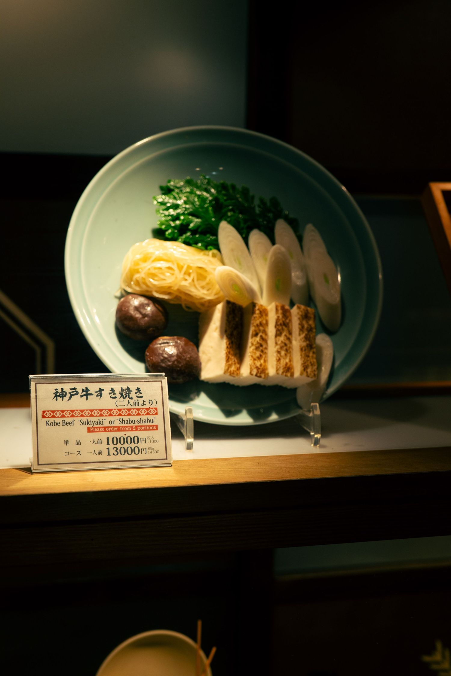 A plate of traditional Japanese cuisine, including a variety of cooked vegetables, fish, and other dishes.