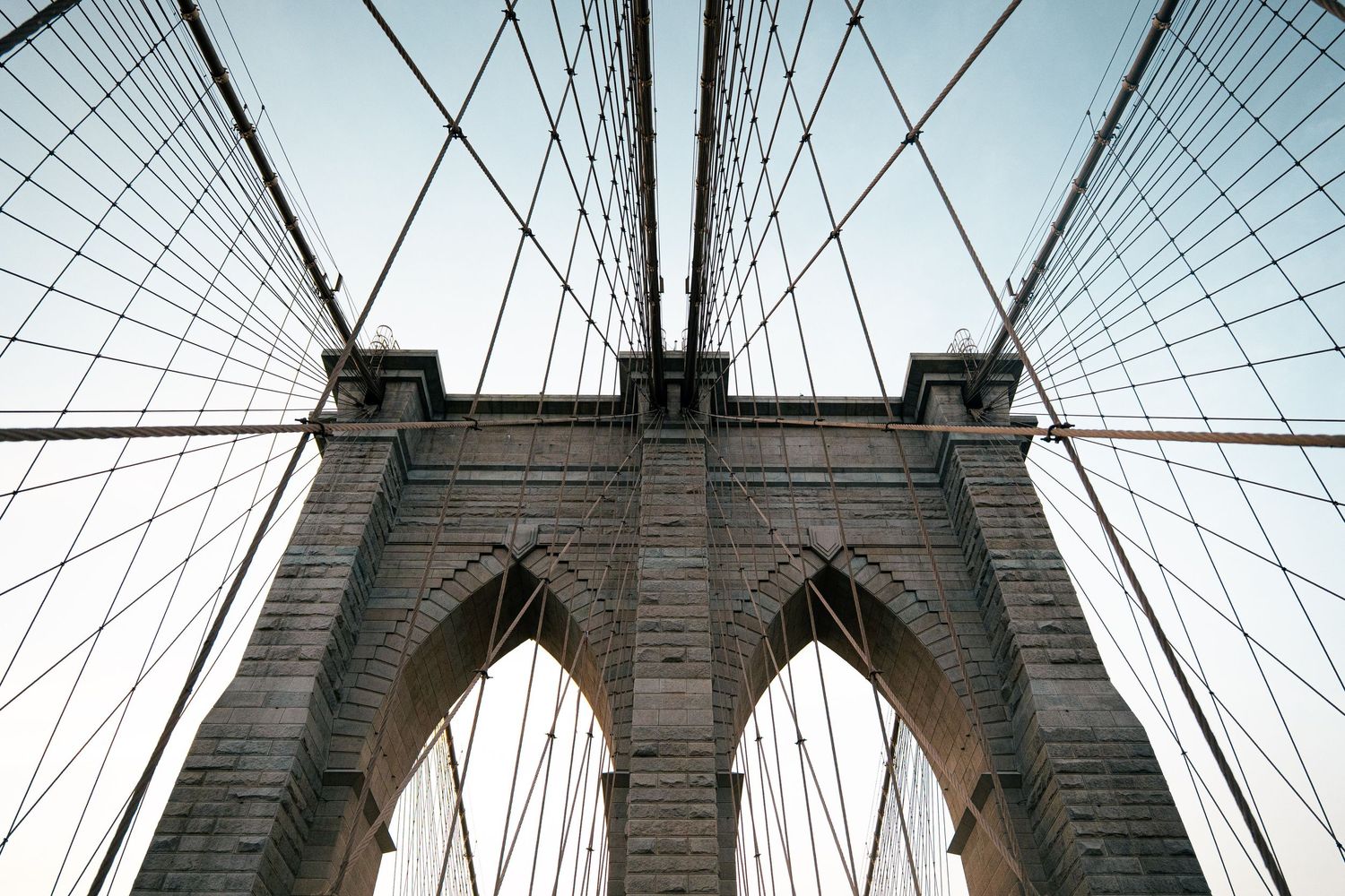 Architectural details of the Brooklyn Bridge, with its iconic suspension cables and towers.