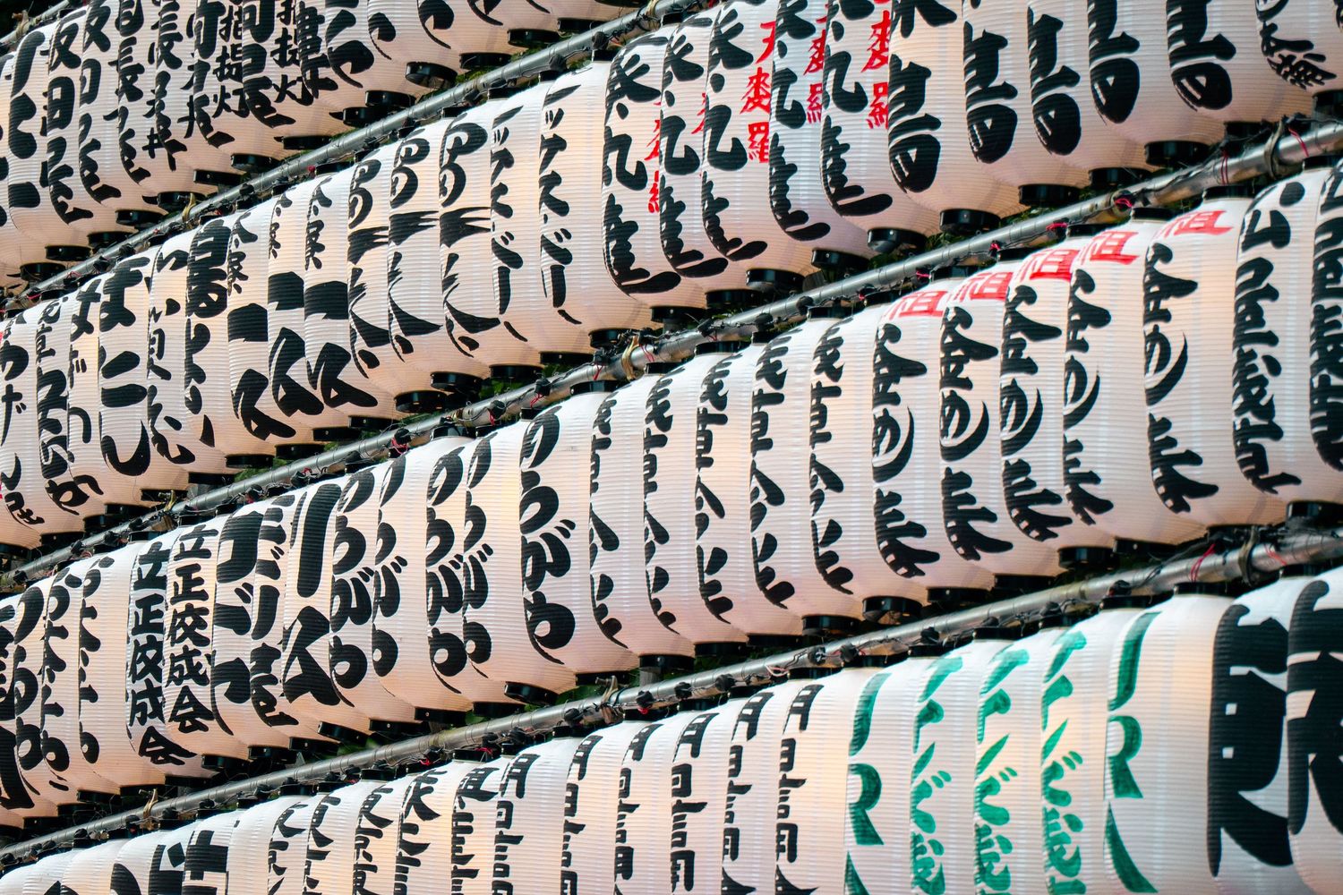 A close-up view of a large collection of vintage analog synthesizers and musical equipment.