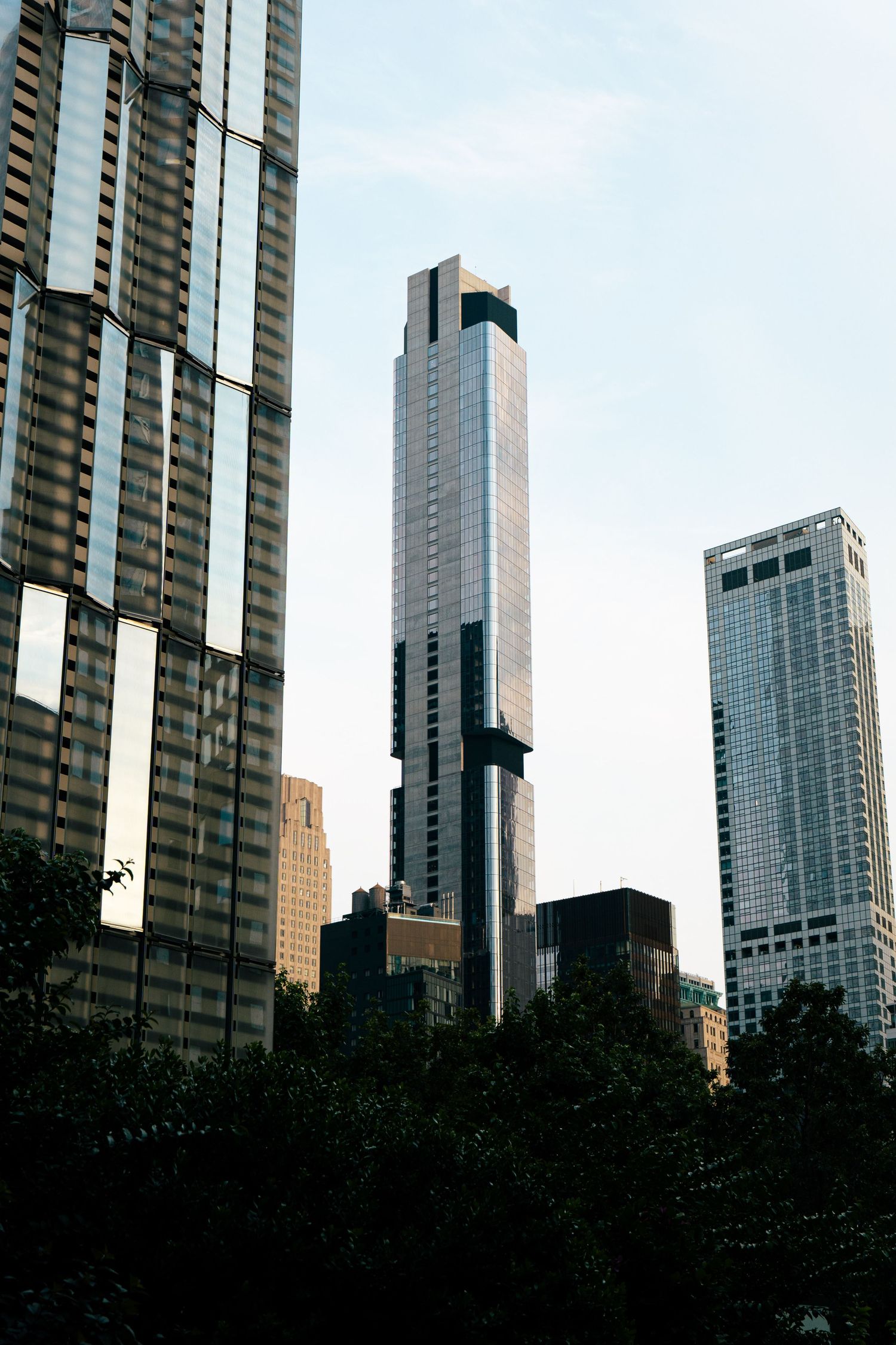 A view of several tall, modern skyscrapers in a city skyline.