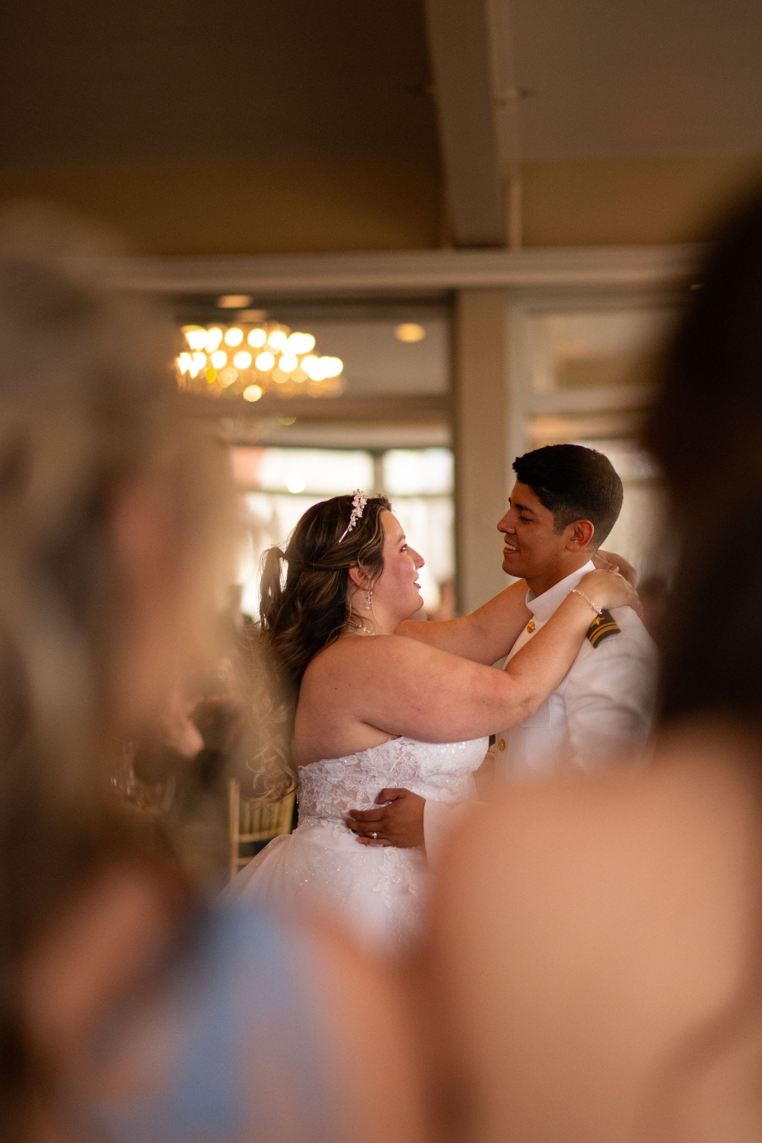 Bride and groom sharing first dance during wedding reception.
