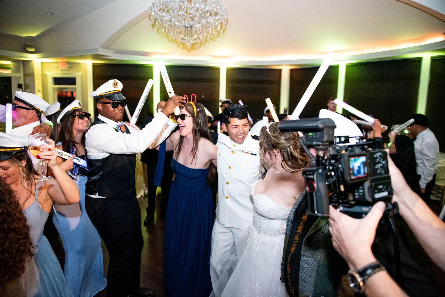 Guests dancing during wedding reception celebration.