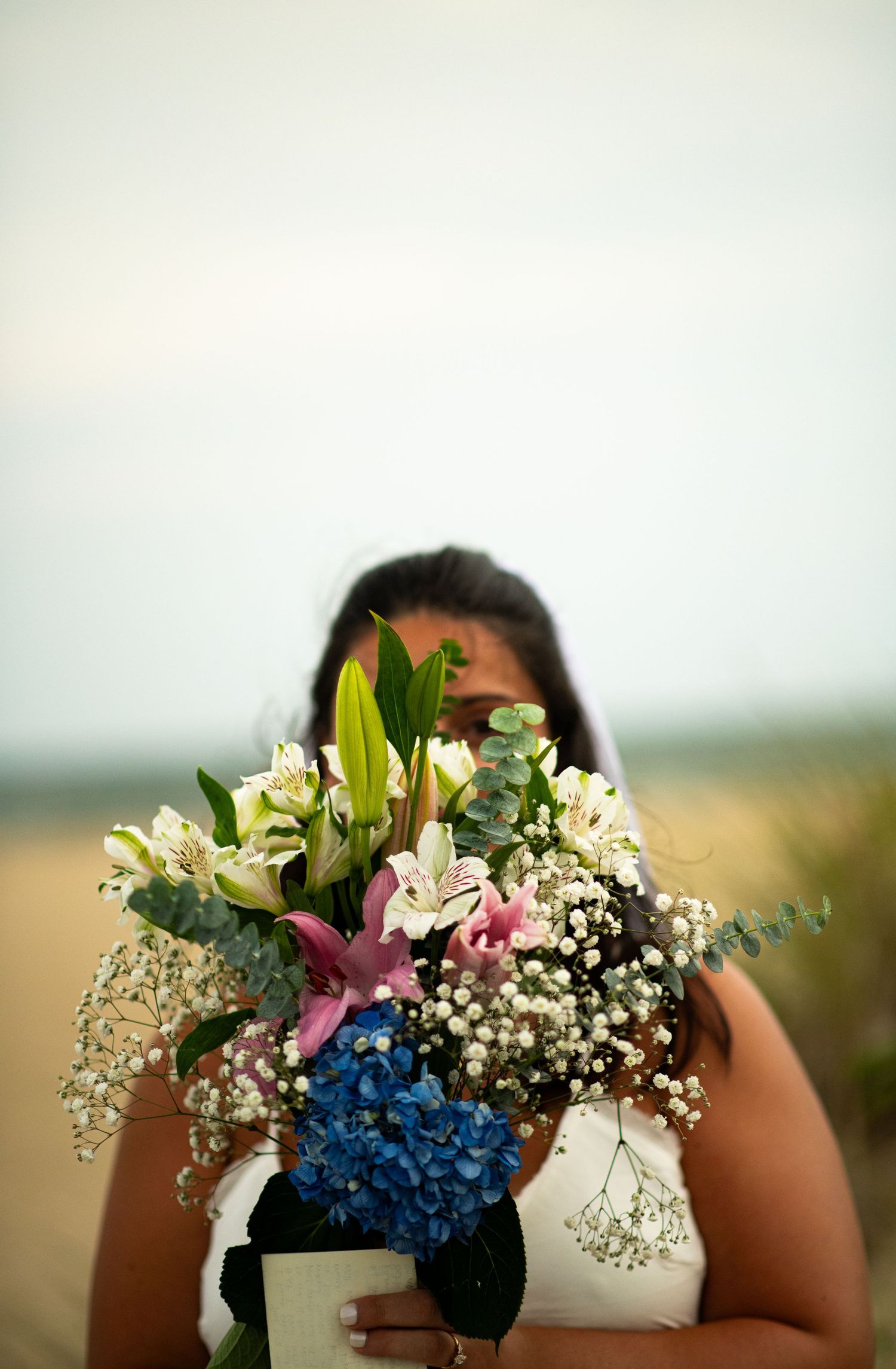 Bride holding bouquet during wedding portrait.