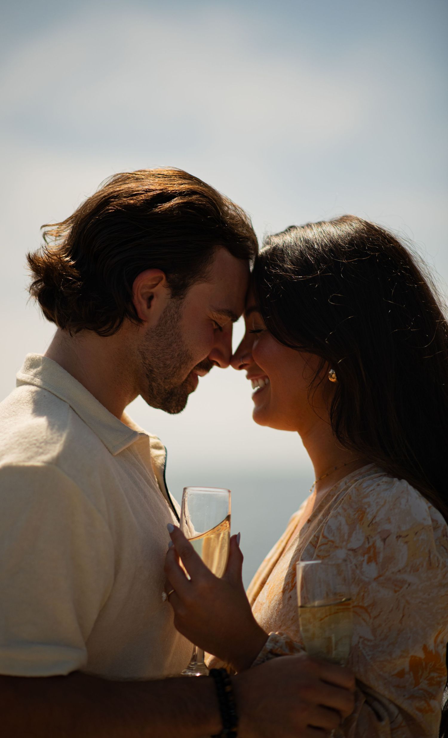 Couple portrait during proposal or engagement session at sunset.
