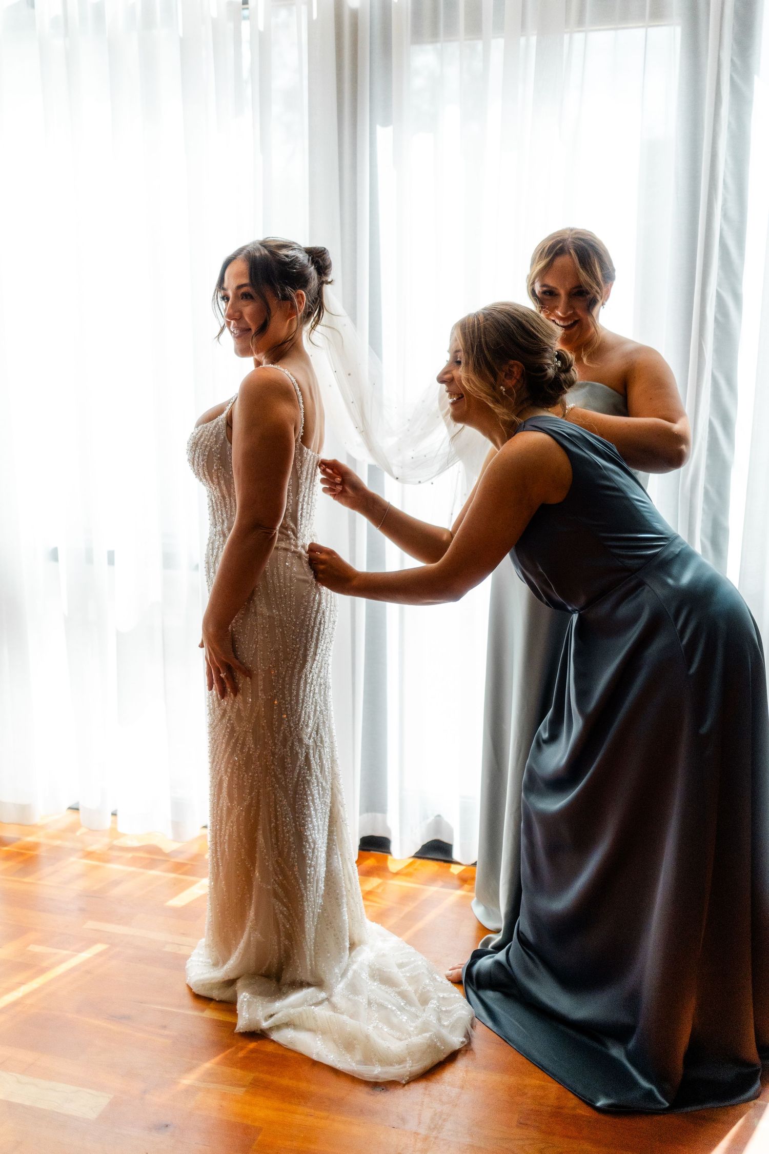Girls helping bride getting ready, Glass House Edinburgh, Scotland,